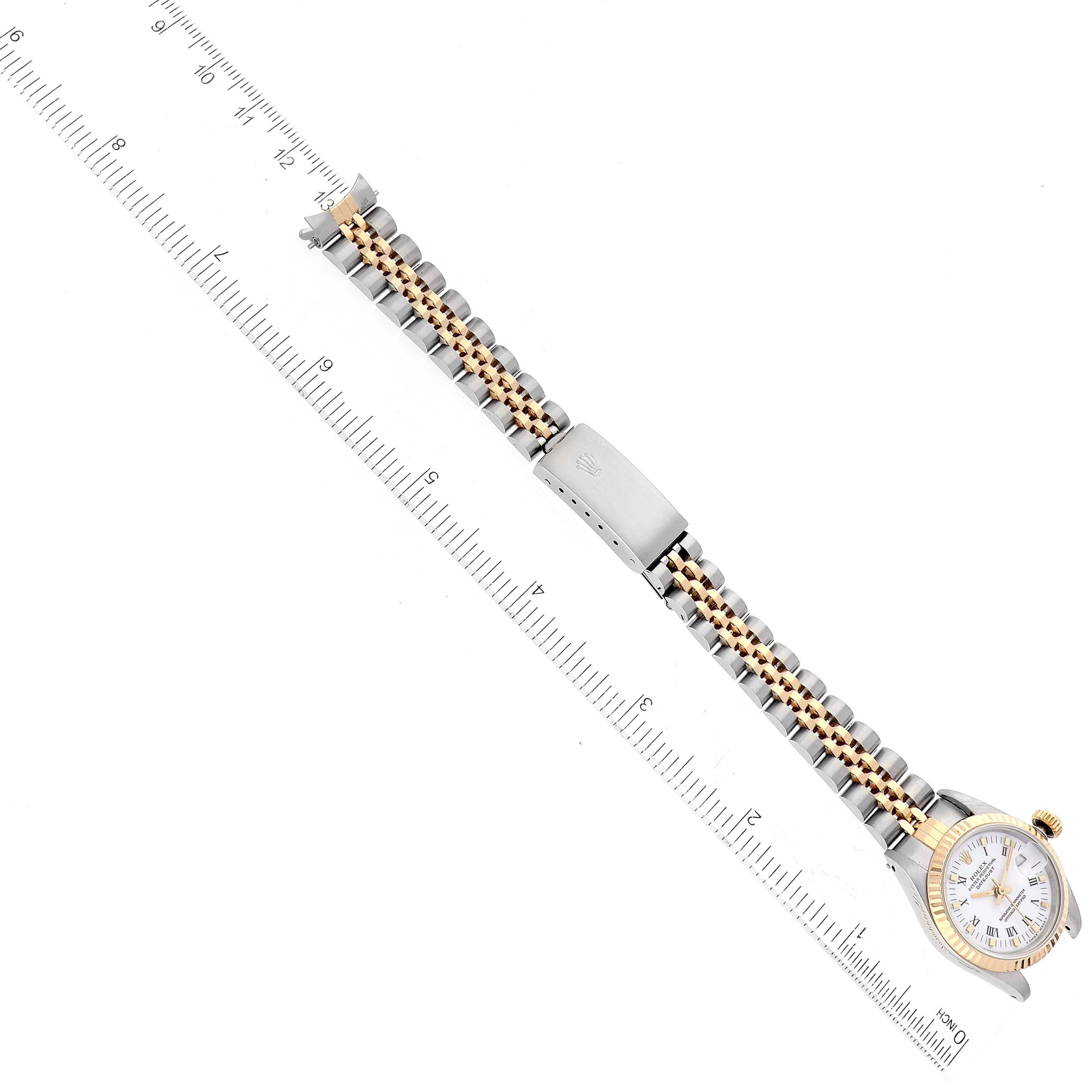 The image shows a Rolex Datejust 69173 Women's Steel and Gold (two tone) White Dial 69173 Women's Steel and Gold (two tone) White Dial watch laid flat, with its gold and silver bracelet extended alongside a ruler for scale.