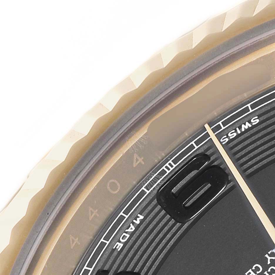 The image shows a close-up of the bezel, part of the dial, and the "Swiss Made" label on a Rolex President 218238 Men's Yellow Gold Black Dial 218238 Men's Yellow Gold Black Dial model watch.