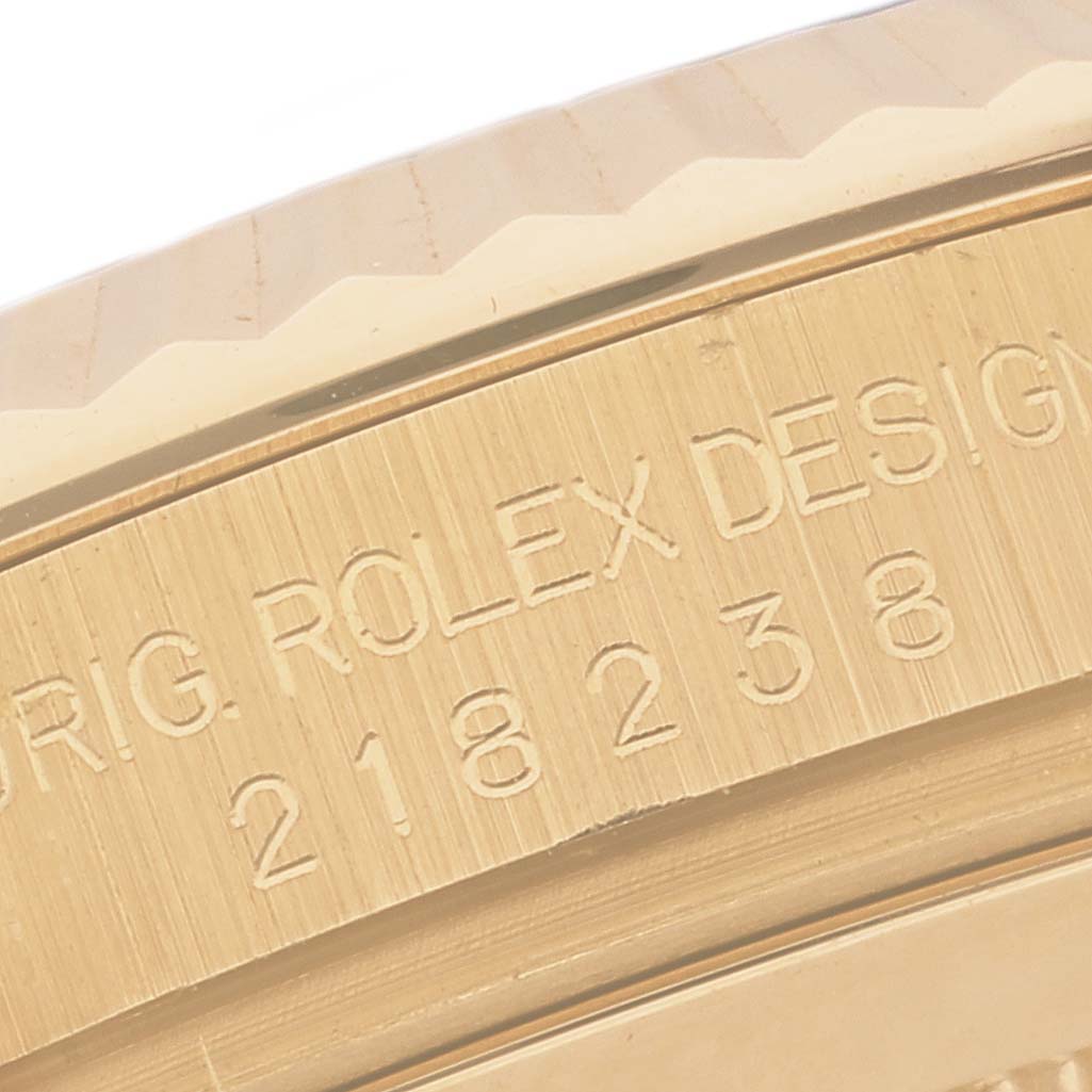 This image shows a close-up of the engraved case side of a Rolex President 218238 Men's Yellow Gold Black Dial 218238 Men's Yellow Gold Black Dial model watch.