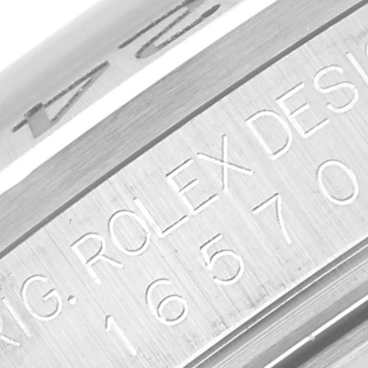 This close-up image shows the engravings on the case side of a Rolex Explorer 16570 Men's Stainless Steel White Dial 16570 Men's Stainless Steel White Dial model.
