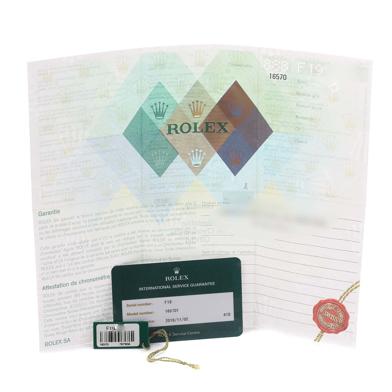 The image shows paperwork and tags for a Rolex Explorer 16570T Men
s Stainless Steel Black Dial 16570T Men
s Stainless Steel Black Dial, including a guarantee document and service tag.