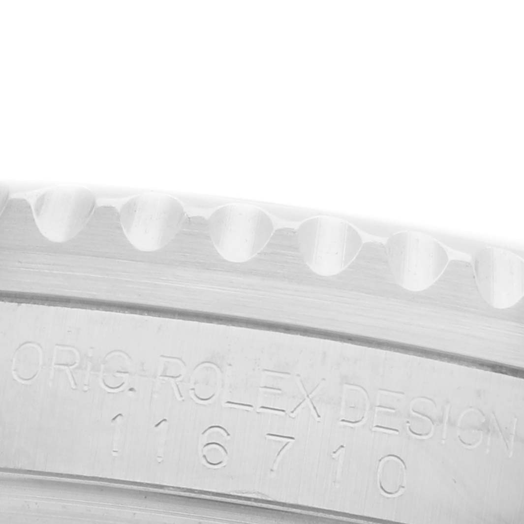 The image shows a close-up of the side edge and engraved model number of a Rolex GMT-Master 116710BLNR Men's Stainless Steel Black Dial 116710BLNR Men's Stainless Steel Black Dial watch case.