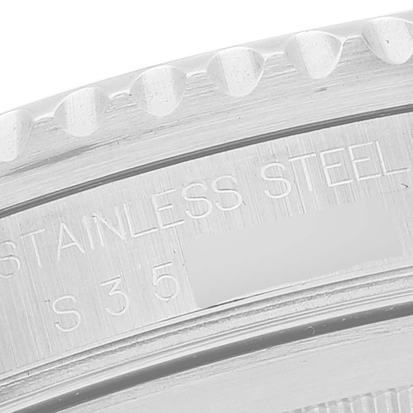 This image shows a close-up of the side bezel and part of the casing of a Rolex GMT-Master 16710 Men
s Stainless Steel Black Dial 16710 Men
s Stainless Steel Black Dial watch, revealing "STAINLESS STEEL" and some numbers.