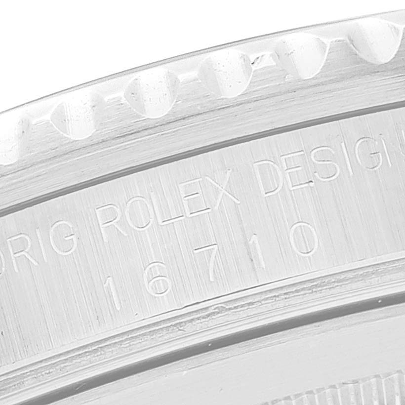 This image shows the side engraving and partial bezel of a Rolex GMT-Master 16710 Men
s Stainless Steel Black Dial 16710 Men
s Stainless Steel Black Dial model 16710.