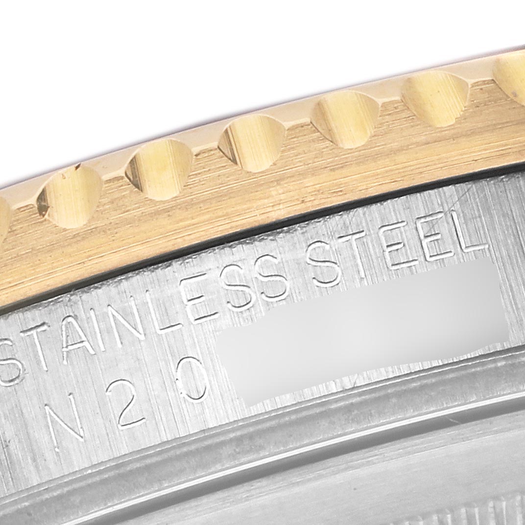 The image shows a close-up of the side of a Rolex GMT-Master 16713 Men's Steel and Gold (two tone) Brown Dial 16713 Men's Steel and Gold (two tone) Brown Dial, focusing on the stainless steel and gold bezel.