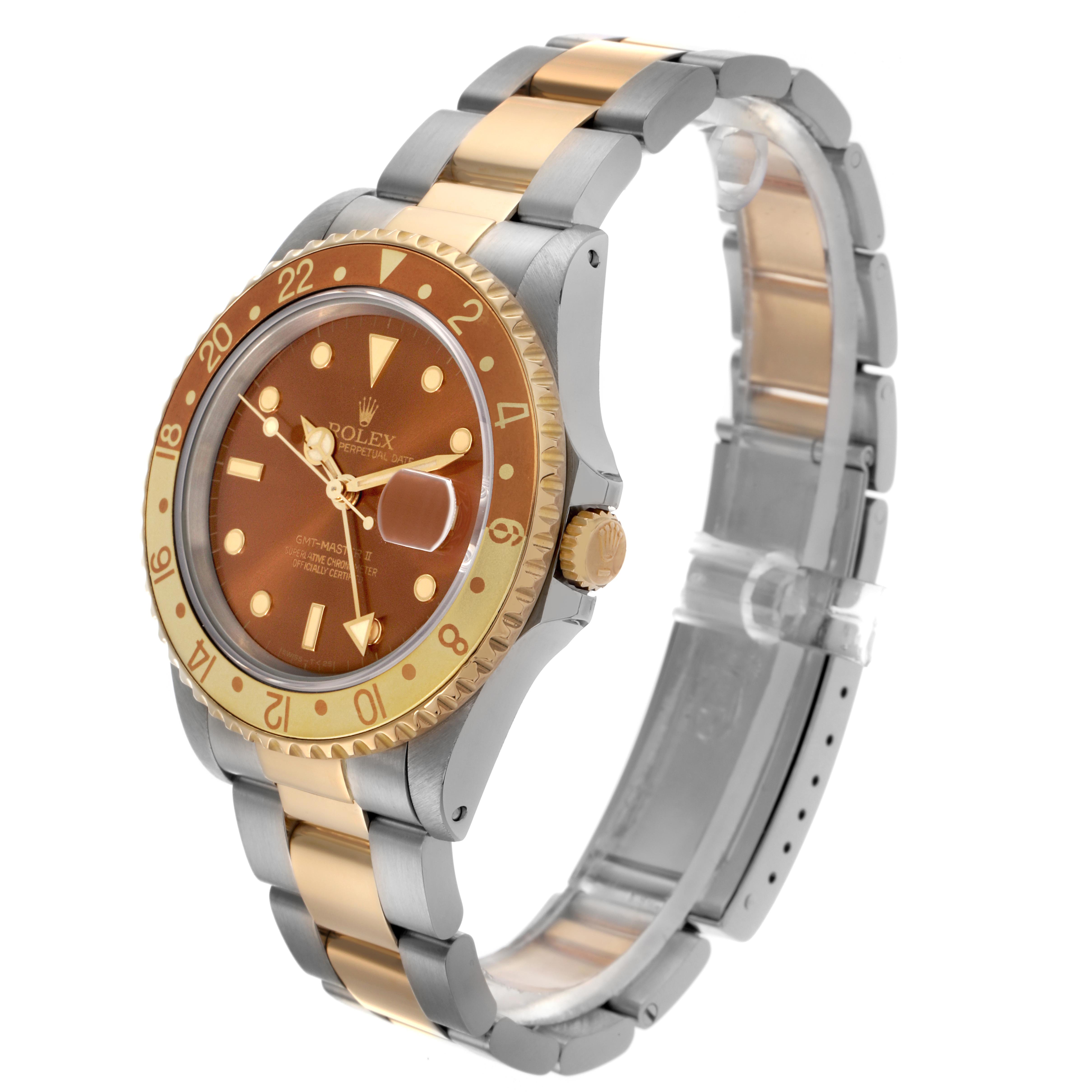 The Rolex GMT-Master 16713 Men's Steel and Gold (two tone) Brown Dial 16713 Men's Steel and Gold (two tone) Brown Dial watch is shown at a slight angle, highlighting its two-tone bracelet, bezel, and crown.