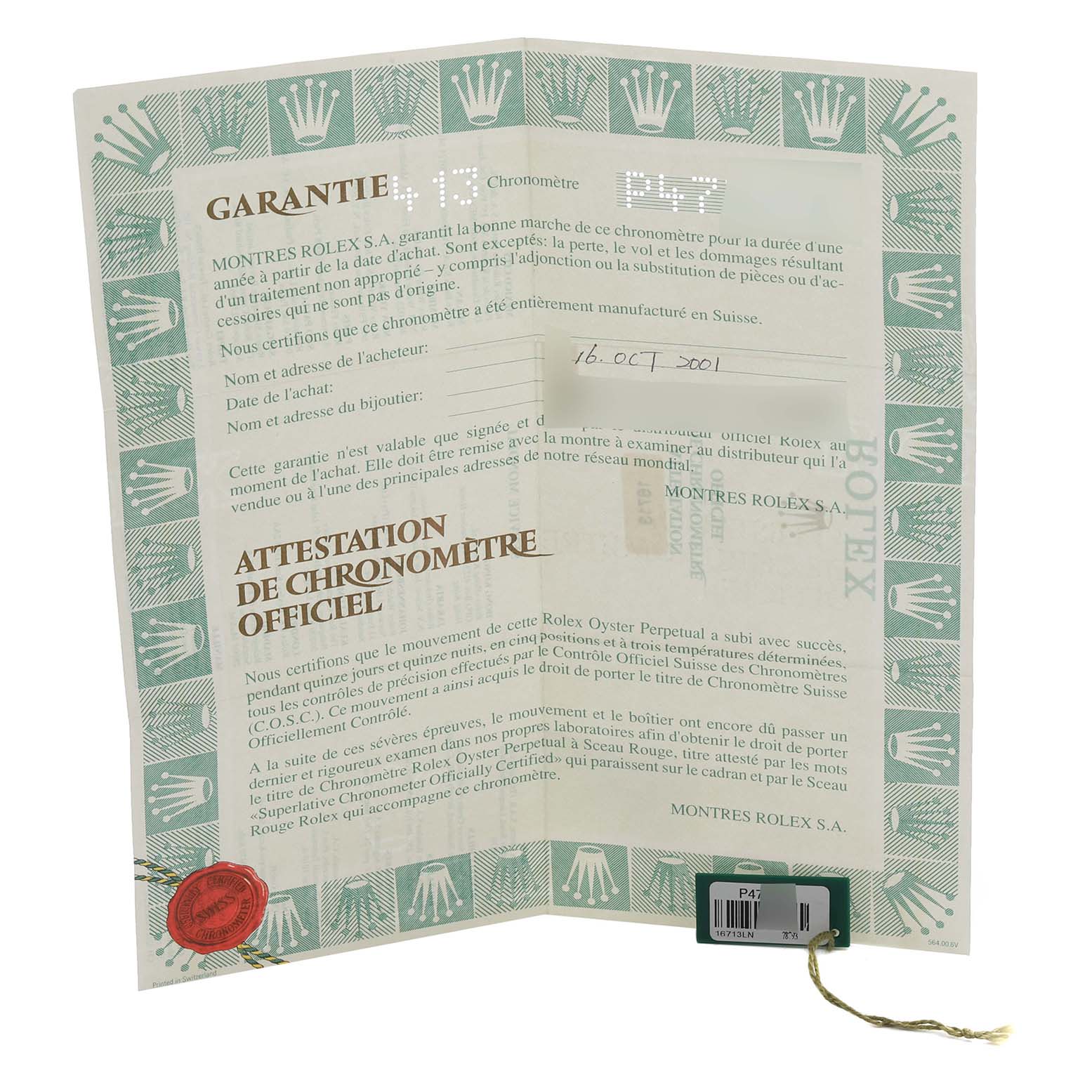 The image shows a warranty certificate for a Rolex GMT-Master 16713LN Men's Steel and Gold (two tone) Black Dial 16713LN Men's Steel and Gold (two tone) Black Dial, featuring text and a seal, viewed from above.