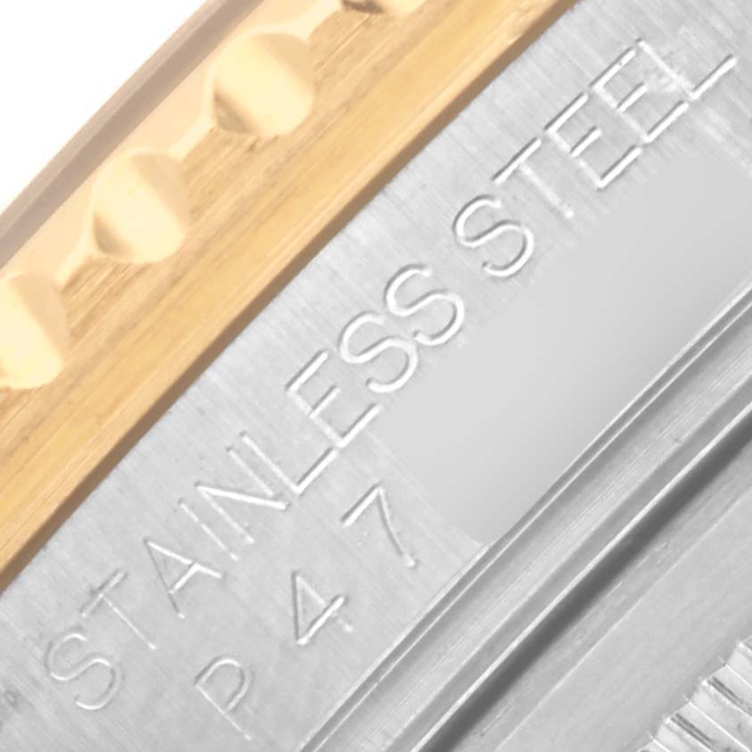 The image shows a close-up of the engraved side of a Rolex GMT-Master 16713LN Men's Steel and Gold (two tone) Black Dial 16713LN Men's Steel and Gold (two tone) Black Dial watch, highlighting the stainless steel and gold materials.