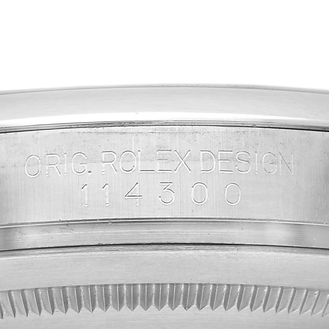 This image shows a close-up of the case side of a Rolex Oyster Perpetual 114300 Men's Stainless Steel Purple Dial 114300 Men's Stainless Steel Purple Dial, featuring the engraved model number 114300.