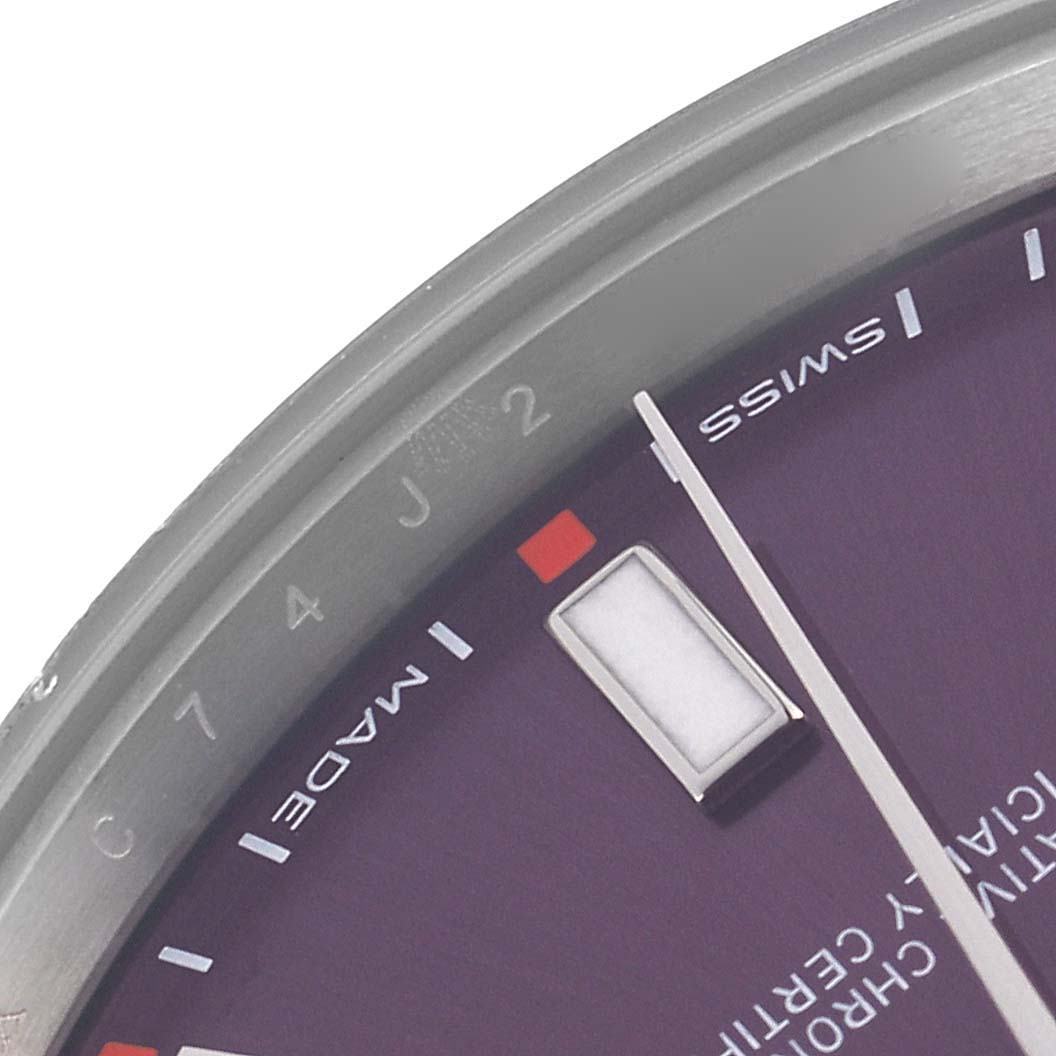 The image shows a close-up of the purple dial and bezel on a Rolex Oyster Perpetual 114300 Men's Stainless Steel Purple Dial 114300 Men's Stainless Steel Purple Dial watch, highlighting the hour markers and hands.