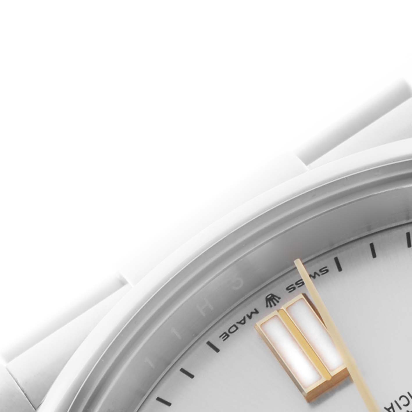 The image shows a partial view of the Rolex Oyster Perpetual 124300 Men's Stainless Steel Silver Dial 124300 Men's Stainless Steel Silver Dial watch, focusing on the bezel and part of the dial near the crown and indices.