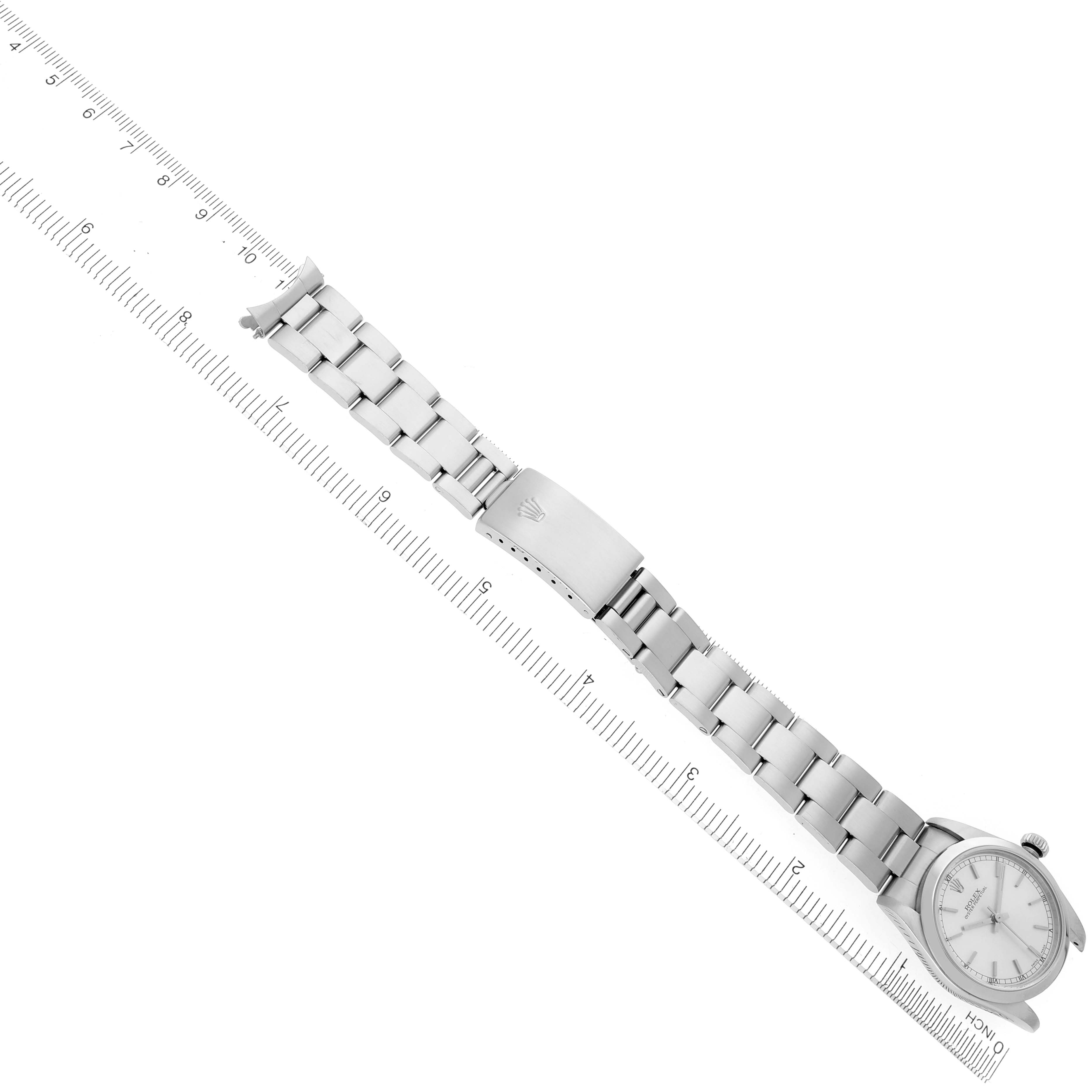 The Rolex Mid-Size 77080 Women's Stainless Steel Silver Dial 77080 Women's Stainless Steel Silver Dial model watch is shown diagonally, displaying its face, bracelet, and clasp alongside a ruler for scale.