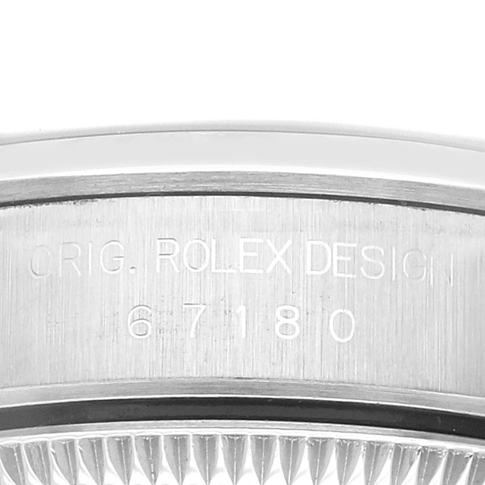 The image shows a close-up of the bezel and case side of a Rolex Oyster Perpetual 67180 Women's Stainless Steel Pink Dial 67180 Women's Stainless Steel Pink Dial watch with the engraving "ORIG. ROLEX DESIGN 67180".