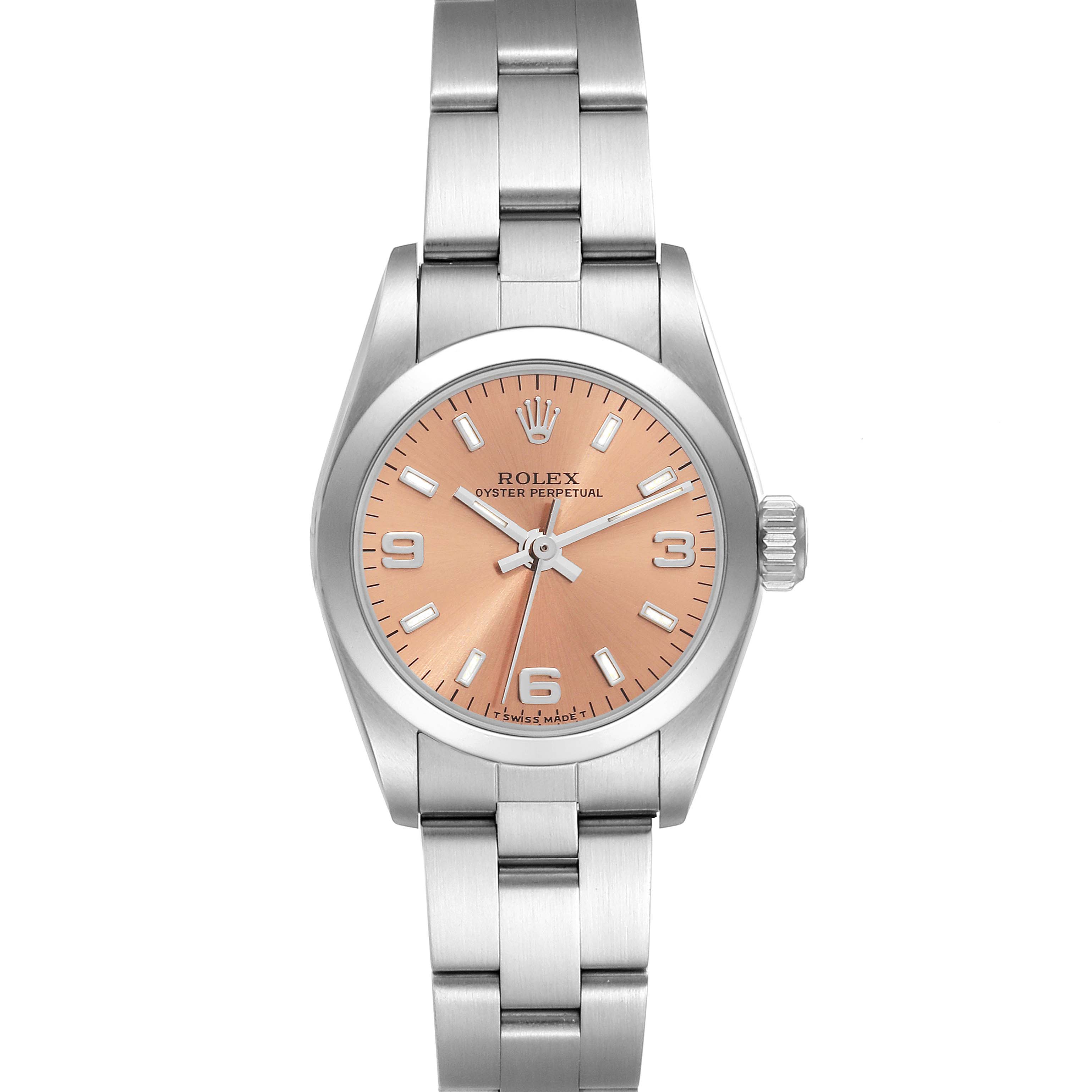 The image shows a front view of the Rolex Oyster Perpetual 67180 Women's Stainless Steel Pink Dial 67180 Women's Stainless Steel Pink Dial watch featuring a salmon-colored dial and a stainless steel bracelet.