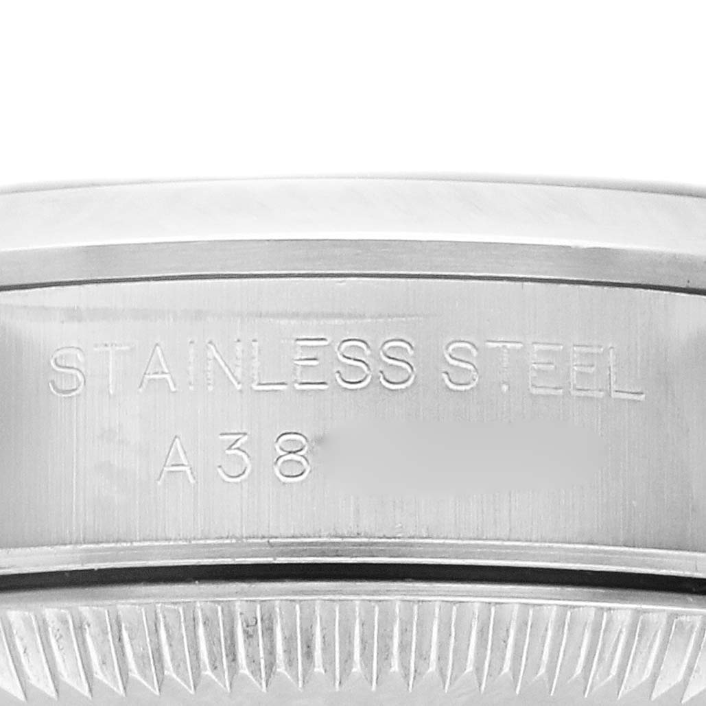 The image shows a side view of a Rolex Oyster Perpetual 76080 Women's Stainless Steel Pink Dial 76080 Women's Stainless Steel Pink Dial watch case, highlighting the stainless steel and engraved details.