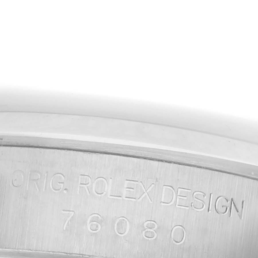 The image shows a close-up of the engraved inner case of a Rolex Oyster Perpetual 76080 Women's Stainless Steel Silver Dial 76080 Women's Stainless Steel Silver Dial watch, displaying the text "ORIG. ROLEX DESIGN 76080".