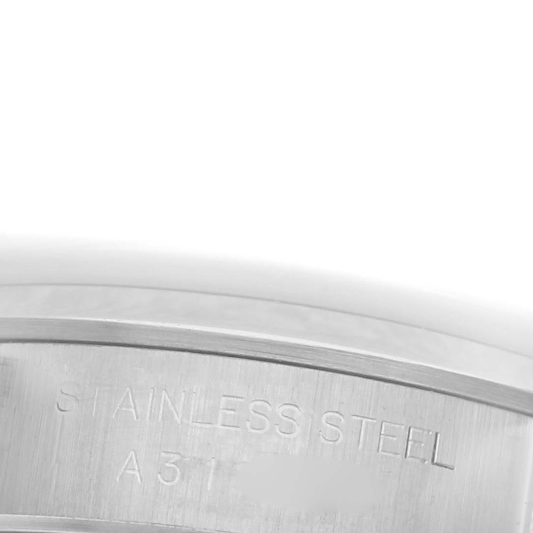 The image shows a close-up of the side of a Rolex Oyster Perpetual 76080 Women's Stainless Steel Silver Dial 76080 Women's Stainless Steel Silver Dial watch case, highlighting the "STAINLESS STEEL" engraving.