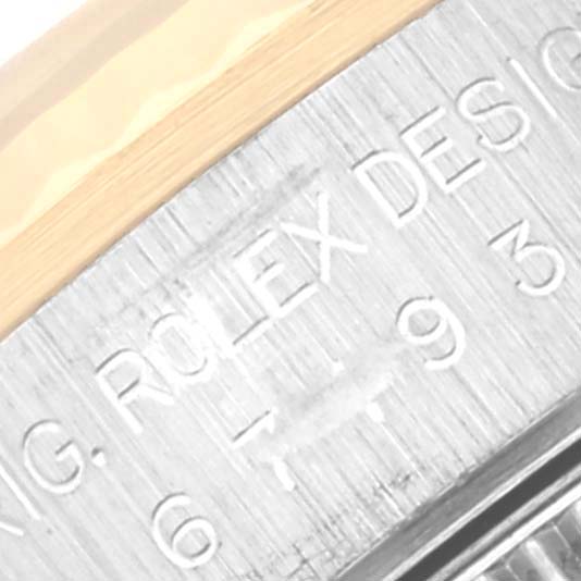 This close-up angle shows the engravings on the side of the bezel of the Rolex Oyster Perpetual 67193 Women's Steel and Gold (two tone) Black Dial 67193 Women's Steel and Gold (two tone) Black Dial watch.
