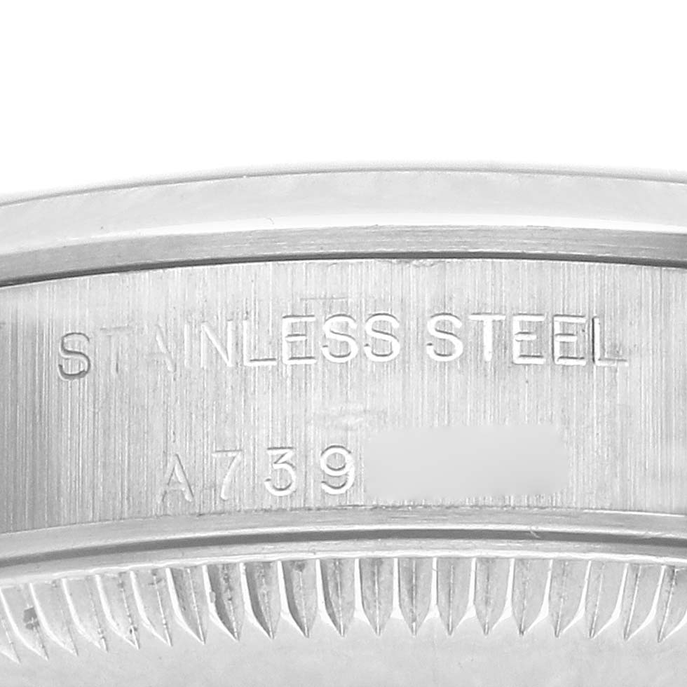 The image shows a close-up of the side view of the case back, displaying the "STAINLESS STEEL" engraving on the Rolex Oyster Perpetual 76080 Women's Stainless Steel White Dial 76080 Women's Stainless Steel White Dial.
