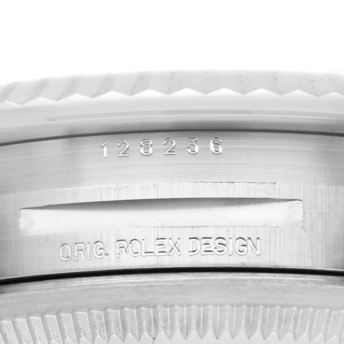 The image shows a close-up of the side of a Rolex President 128236 Men's Platinum Blue Dial watch case with the model number "128236" and "ORIG. ROLEX DESIGN" engraved.