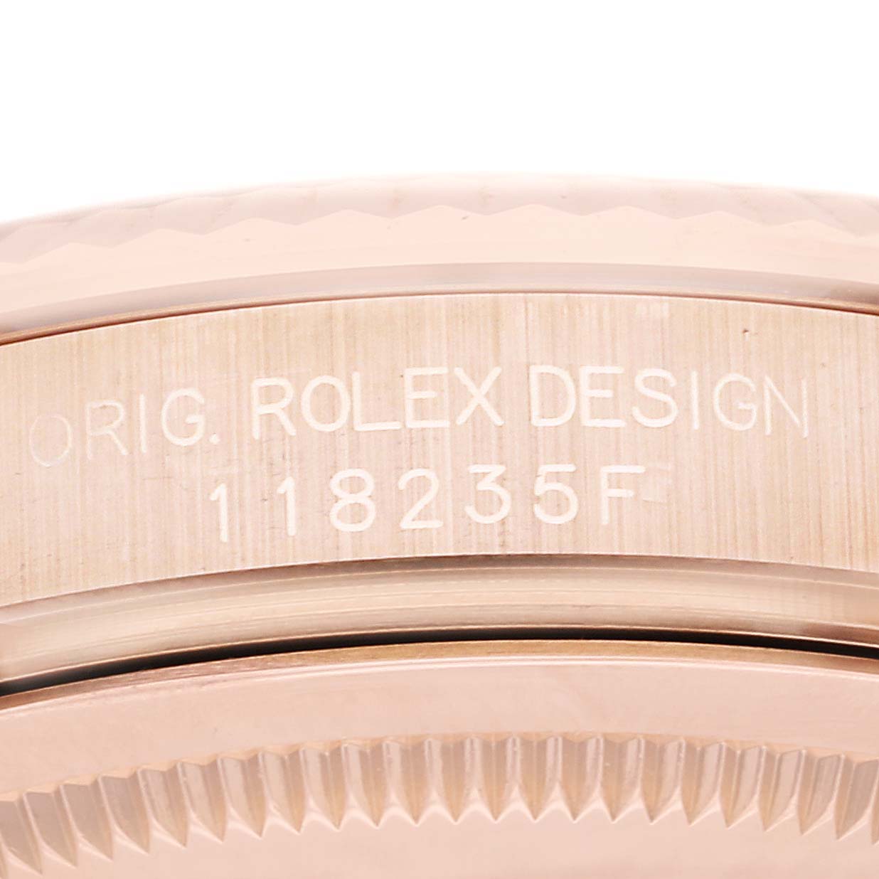 This image shows the side view of a Rolex President 118235 Men's Rose Gold Silver Dial 118235 Men's Rose Gold Silver Dial model watch case with engraved text indicating the model number.