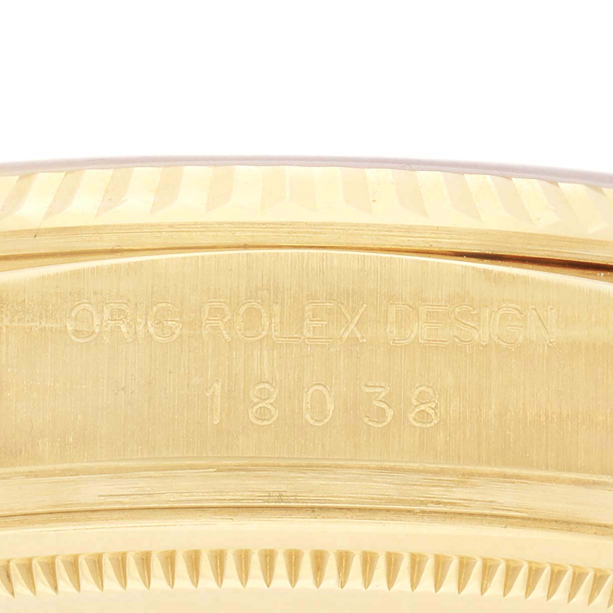 The image shows the side view of a Rolex President 18038 Men's Yellow Gold Champagne Dial 18038 Men's Yellow Gold Champagne Dial model, focusing on the engraved serial number and design details.