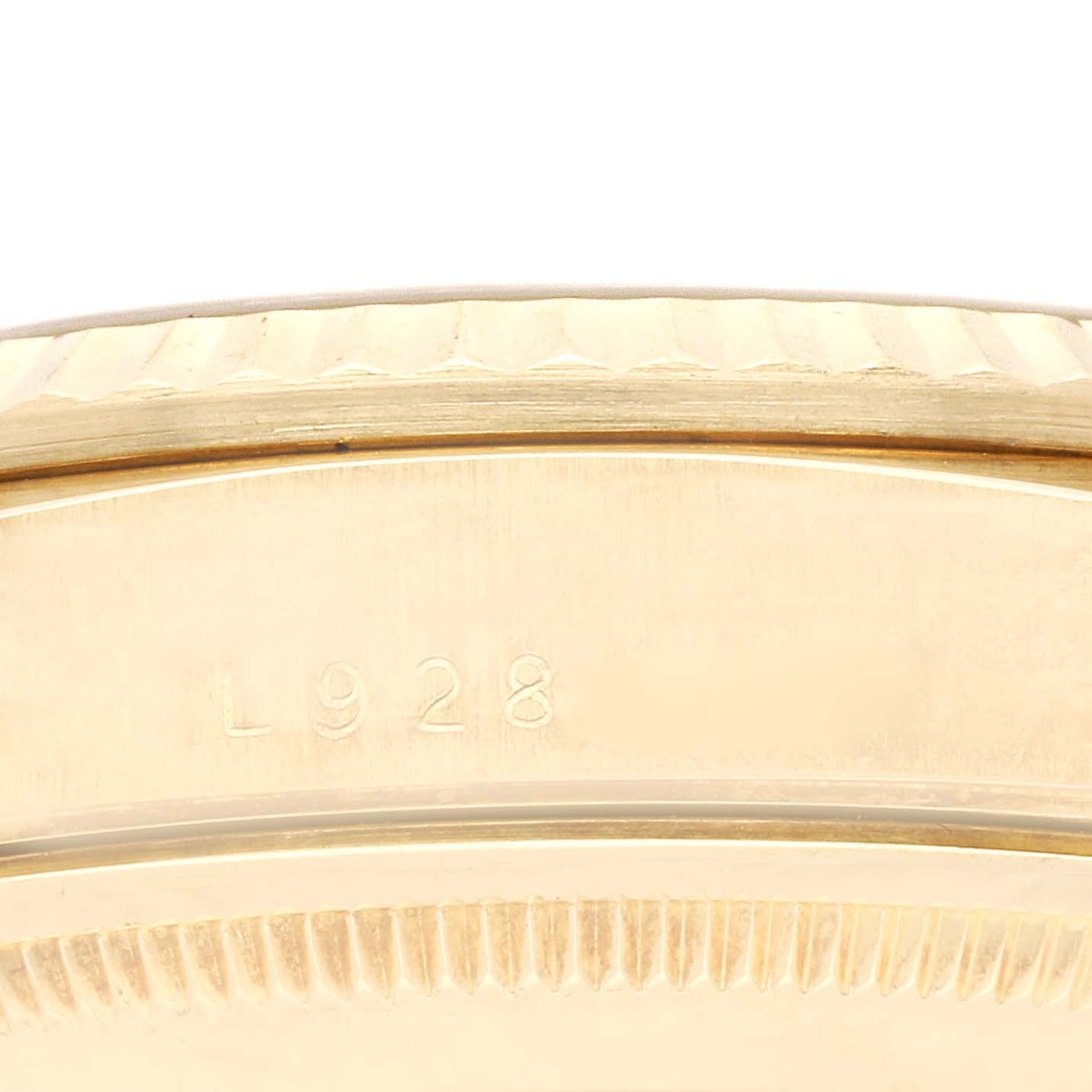 The image shows a close-up of a serial number and the fluted bezel on a Rolex President 18238 Men
s Yellow Gold Champagne Dial 18238 Men
s Yellow Gold Champagne Dial watch.