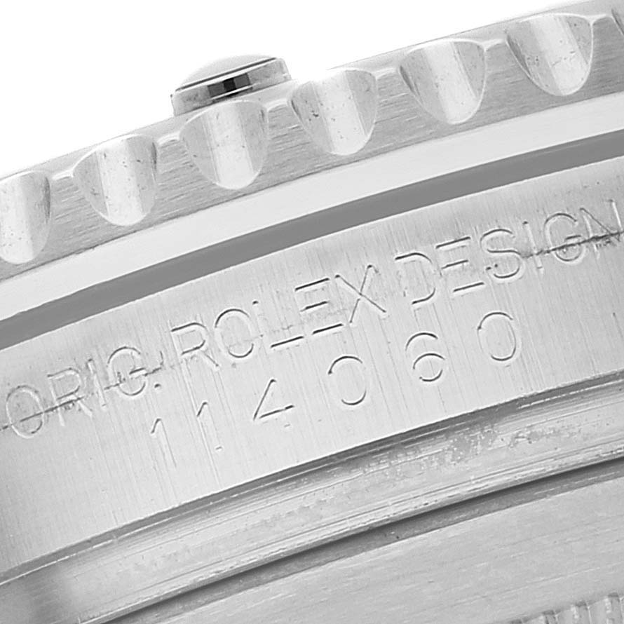 This close-up shows the case engraving and edge of the bezel of a Rolex Submariner 114060 Men's Stainless Steel Black Dial 114060 Men's Stainless Steel Black Dial watch.