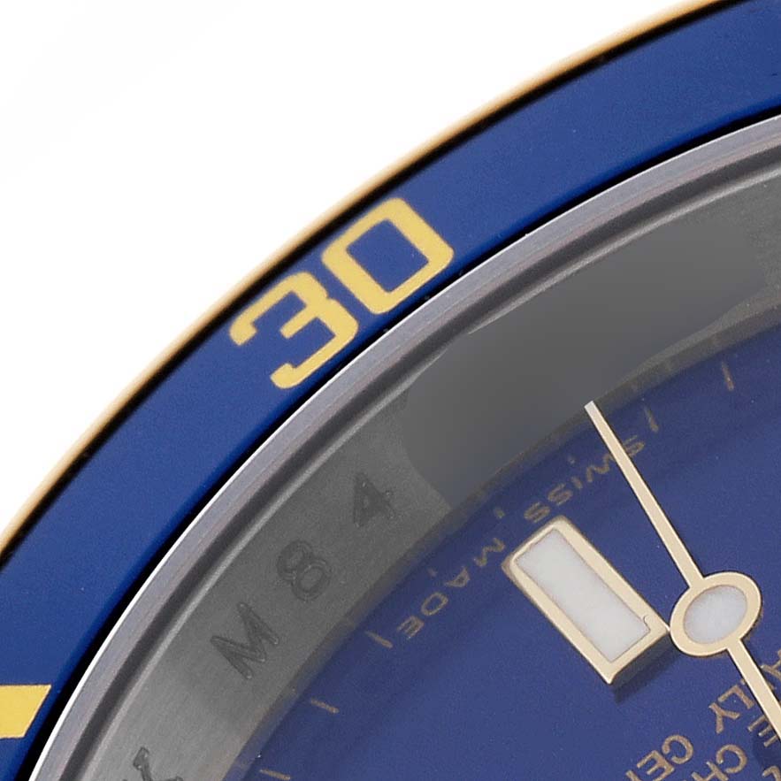 The image shows a close-up of the bezel and part of the dial of a Rolex Submariner 16613 Men's Steel and Gold (two tone) Blue Dial 16613 Men's Steel and Gold (two tone) Blue Dial watch.