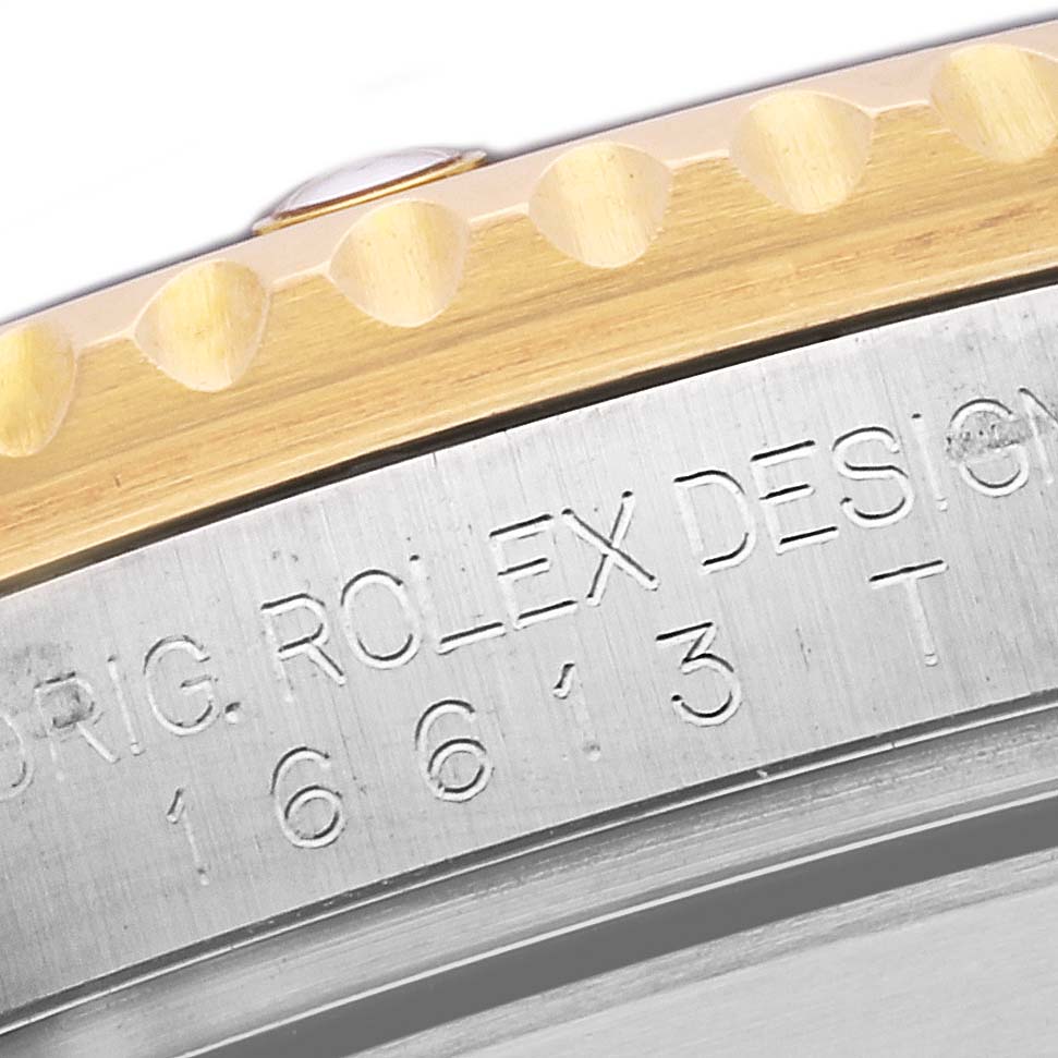 The image shows a close-up of the case side with the model number and part of the bezel of a Rolex Submariner 16613 Men's Steel and Gold (two tone) Blue Dial 16613 Men's Steel and Gold (two tone) Blue Dial watch.