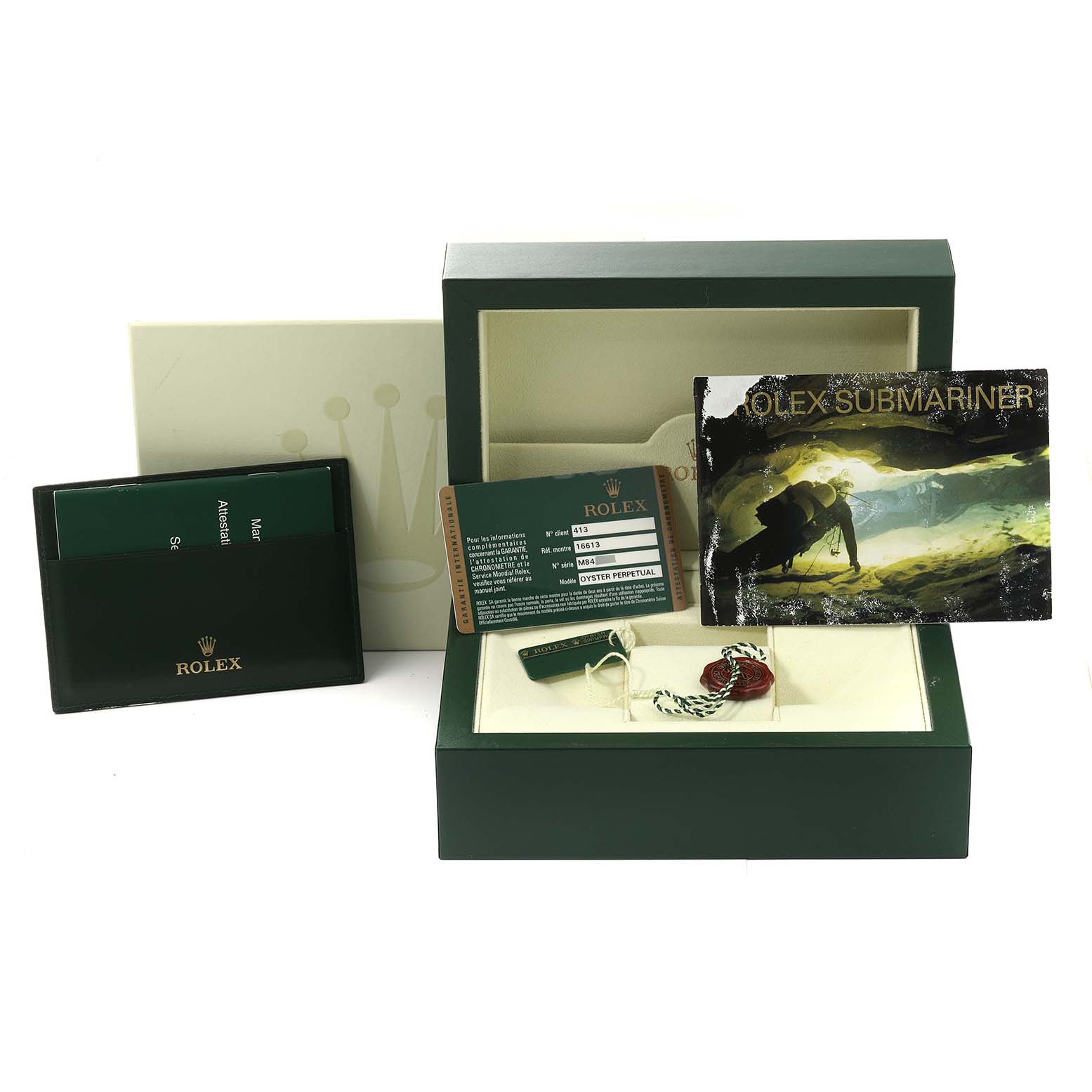 The image shows a Rolex Submariner 16613 Men's Steel and Gold (two tone) Blue Dial 16613 Men's Steel and Gold (two tone) Blue Dial watch box set, including tags, warranty cards, a booklet, and the box itself.