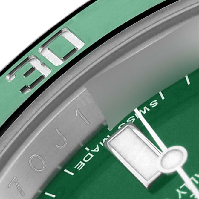 The image shows a macro view of the Rolex Submariner 116610LV Men's Stainless Steel Green Dial 116610LV Men's Stainless Steel Green Dial's green bezel, dial edge, and hour marker.