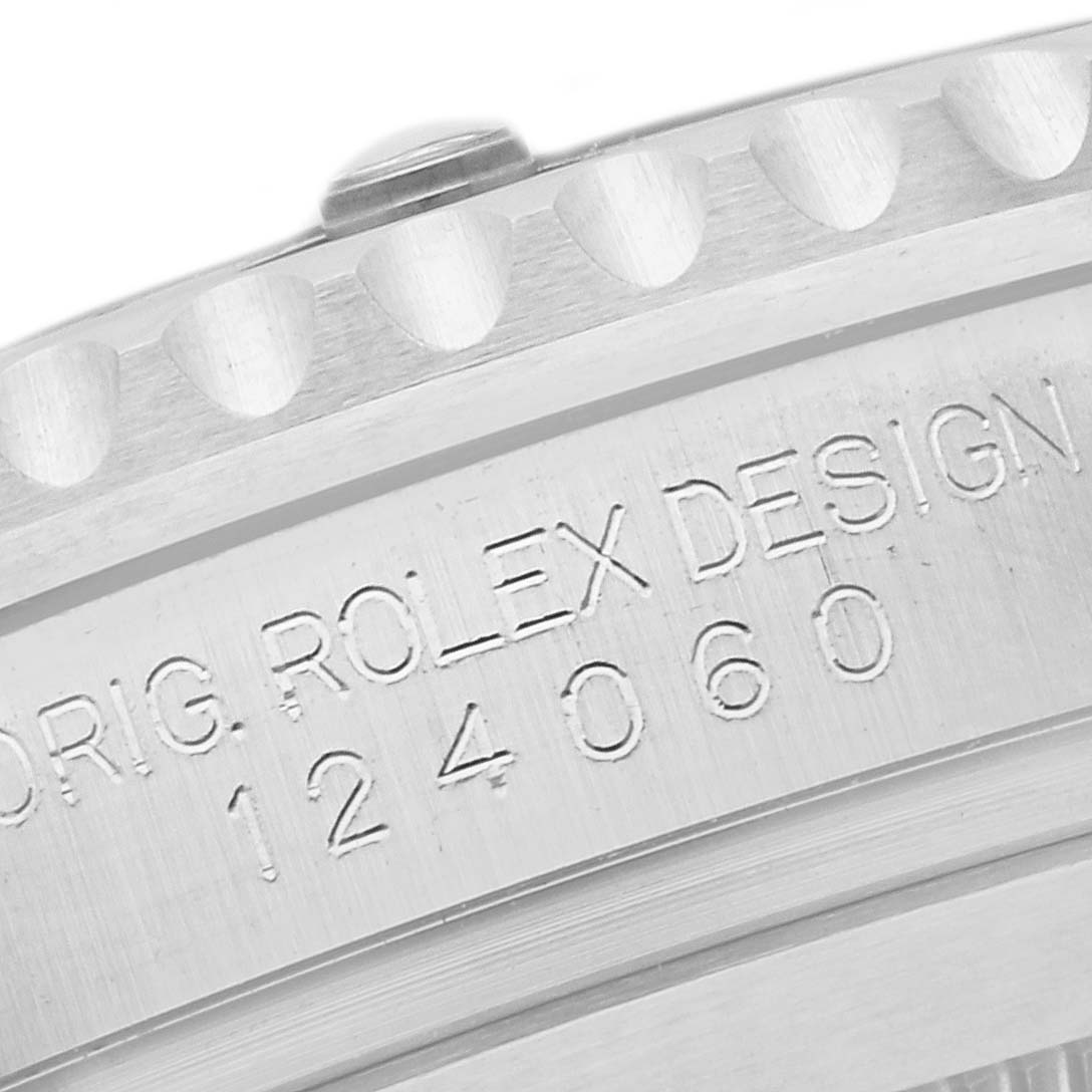 The image shows a close-up of the engraved caseback of a Rolex Submariner 124060 Men
s Stainless Steel Black Dial 124060 Men
s Stainless Steel Black Dial watch, displaying the model number 124060 and part of the serrated bezel.