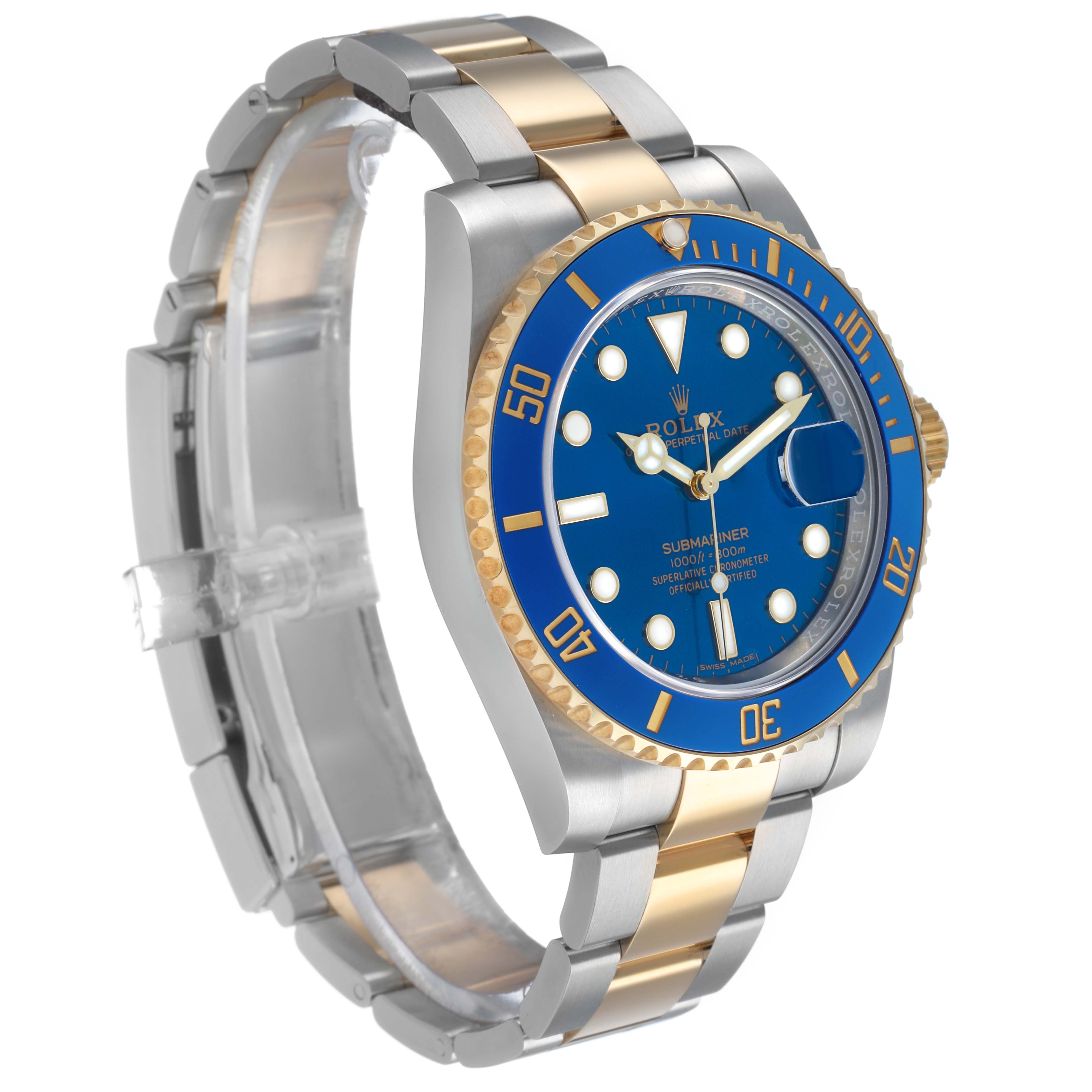 The Rolex Submariner 116613 Men's Steel and Gold (two tone) Blue Dial is shown at a three-quarter angle, highlighting the blue dial, bezel, and two-tone bracelet.