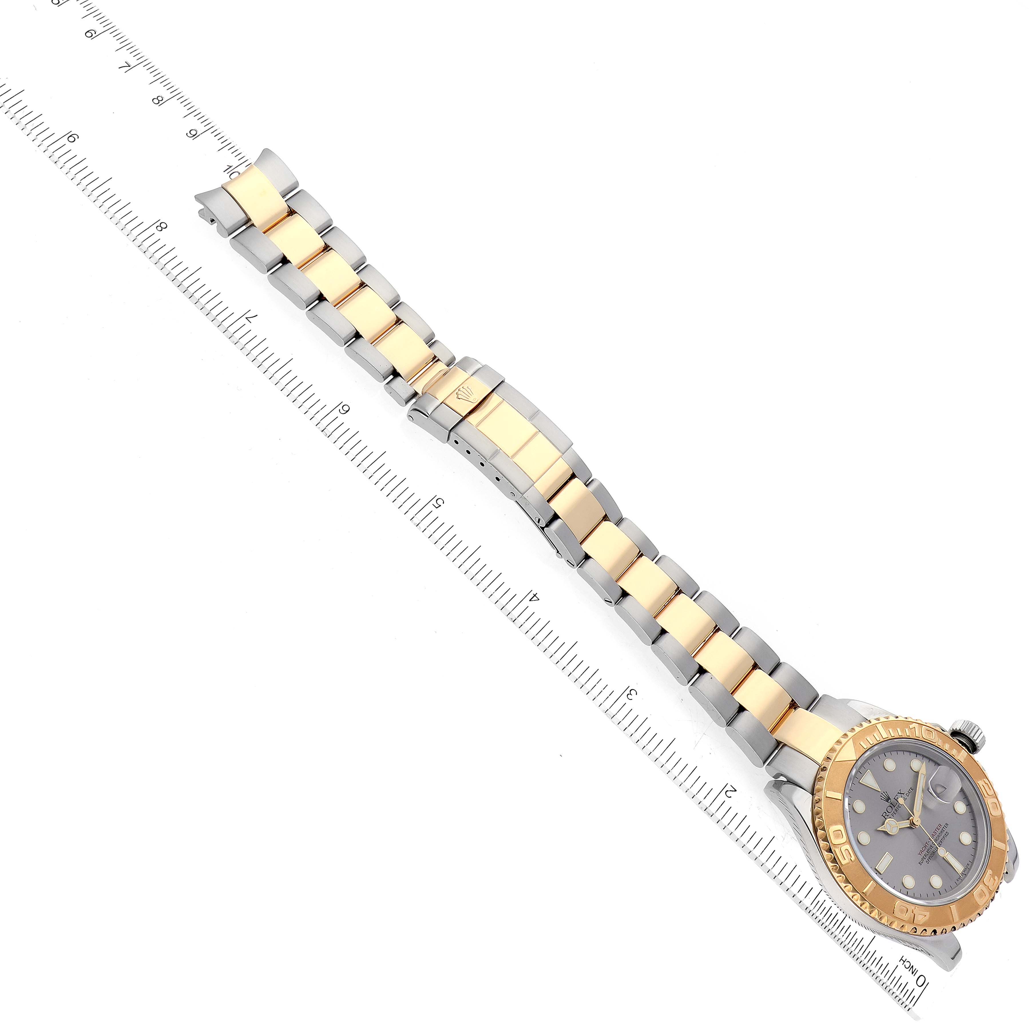 This image shows a Rolex Yacht-Master 16623 Men's Steel and Gold (two tone) Grey Dial 16623 Men's Steel and Gold (two tone) Grey Dial watch laid flat with a ruler next to it, highlighting the bracelet and dial.