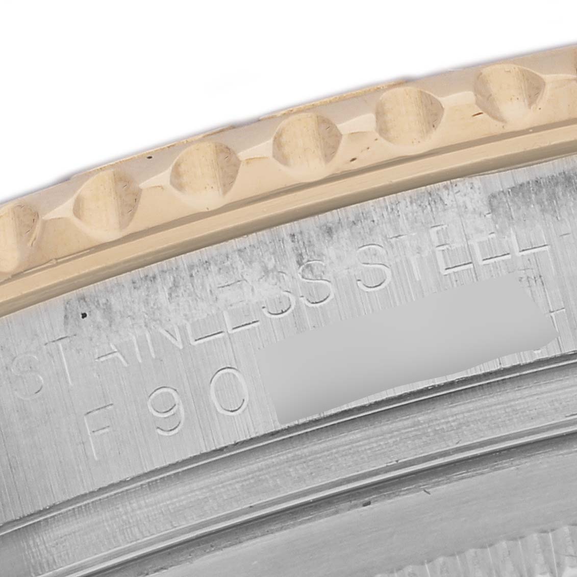 This close-up image shows part of the stainless steel casing and engraved text of the Rolex Yacht-Master 16623 Men's Steel and Gold (two tone) Grey Dial 16623 Men's Steel and Gold (two tone) Grey Dial watch.