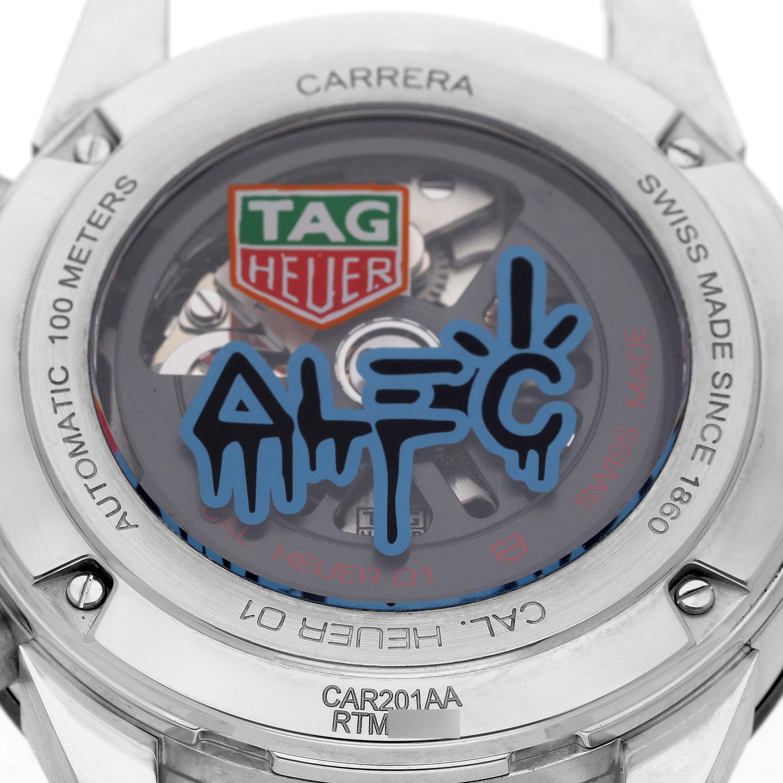 The image shows the back of a Tag Heuer Carrera CAR201AA.BA0714 Men's Stainless Steel White Dial watch with a visible automatic movement and brand engraving.