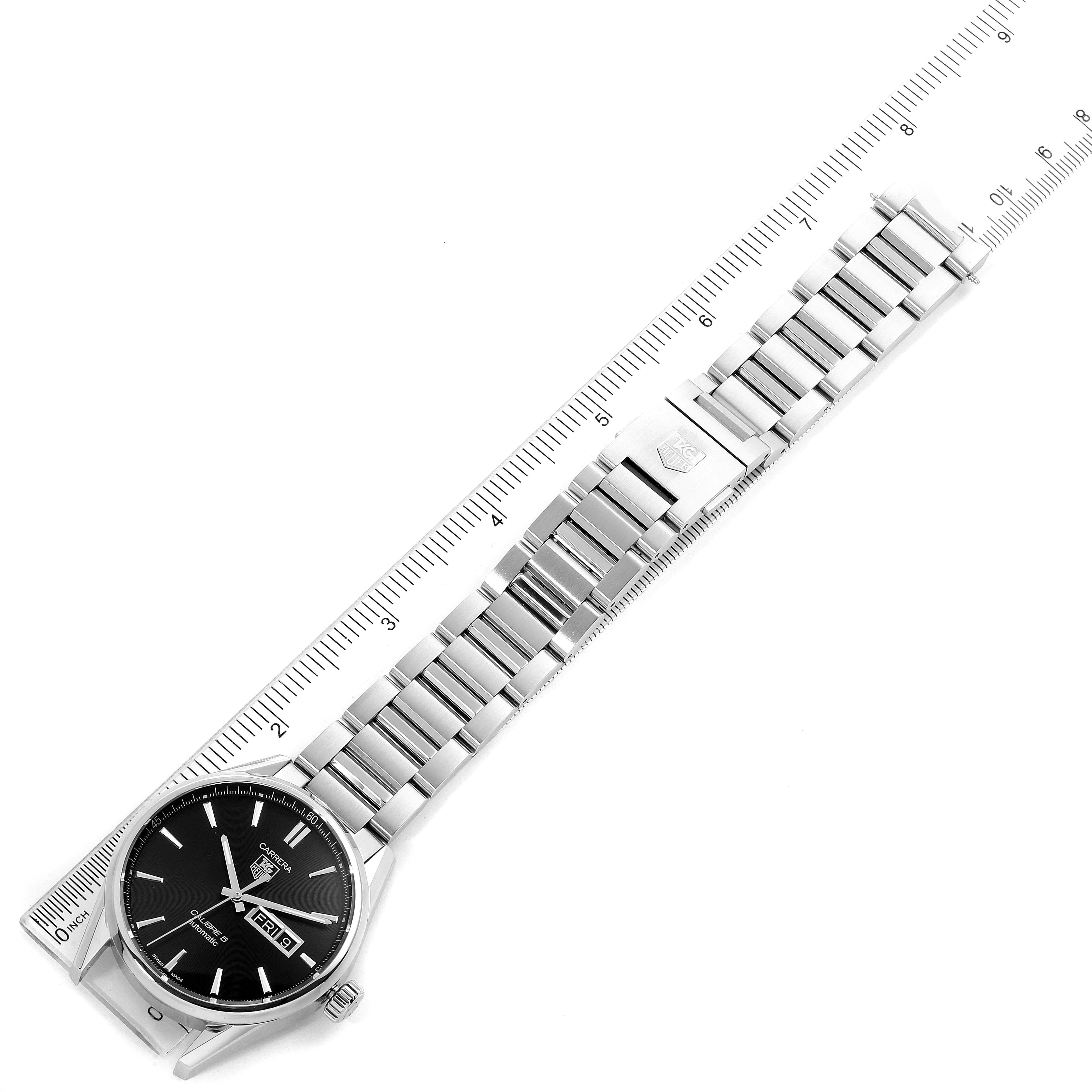 The image shows a Tag Heuer Carrera WAR201A.BA0723 Men
s Stainless Steel Black Dial WAR201A.BA0723 Men
s Stainless Steel Black Dial watch laid flat with its metal bracelet extended next to a ruler for measurement.