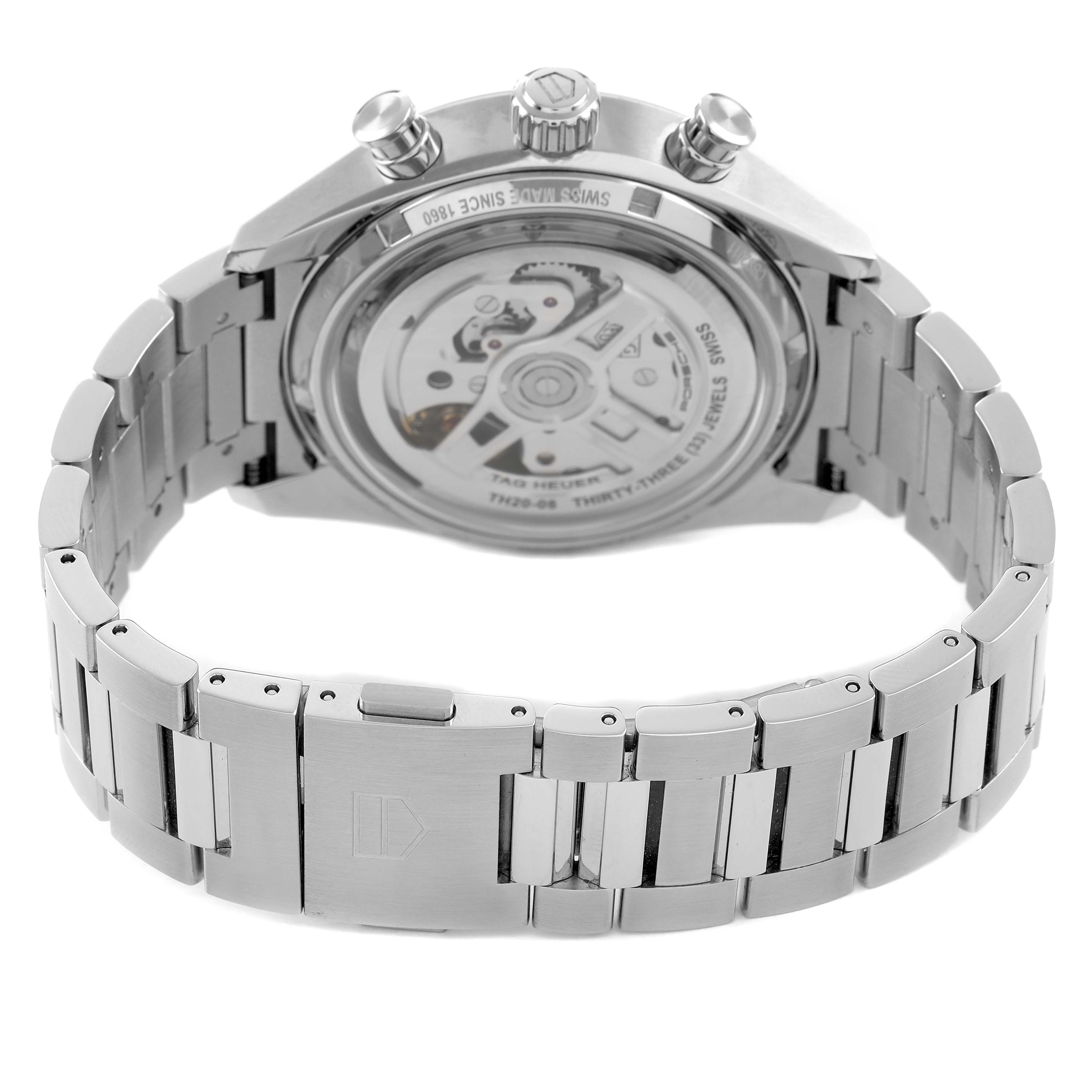 The image shows the back of a Tag Heuer Carrera CBS2011.FC6529 Men's Stainless Steel Silver Dial watch, highlighting the bracelet, clasp, and transparent case back with visible movement.