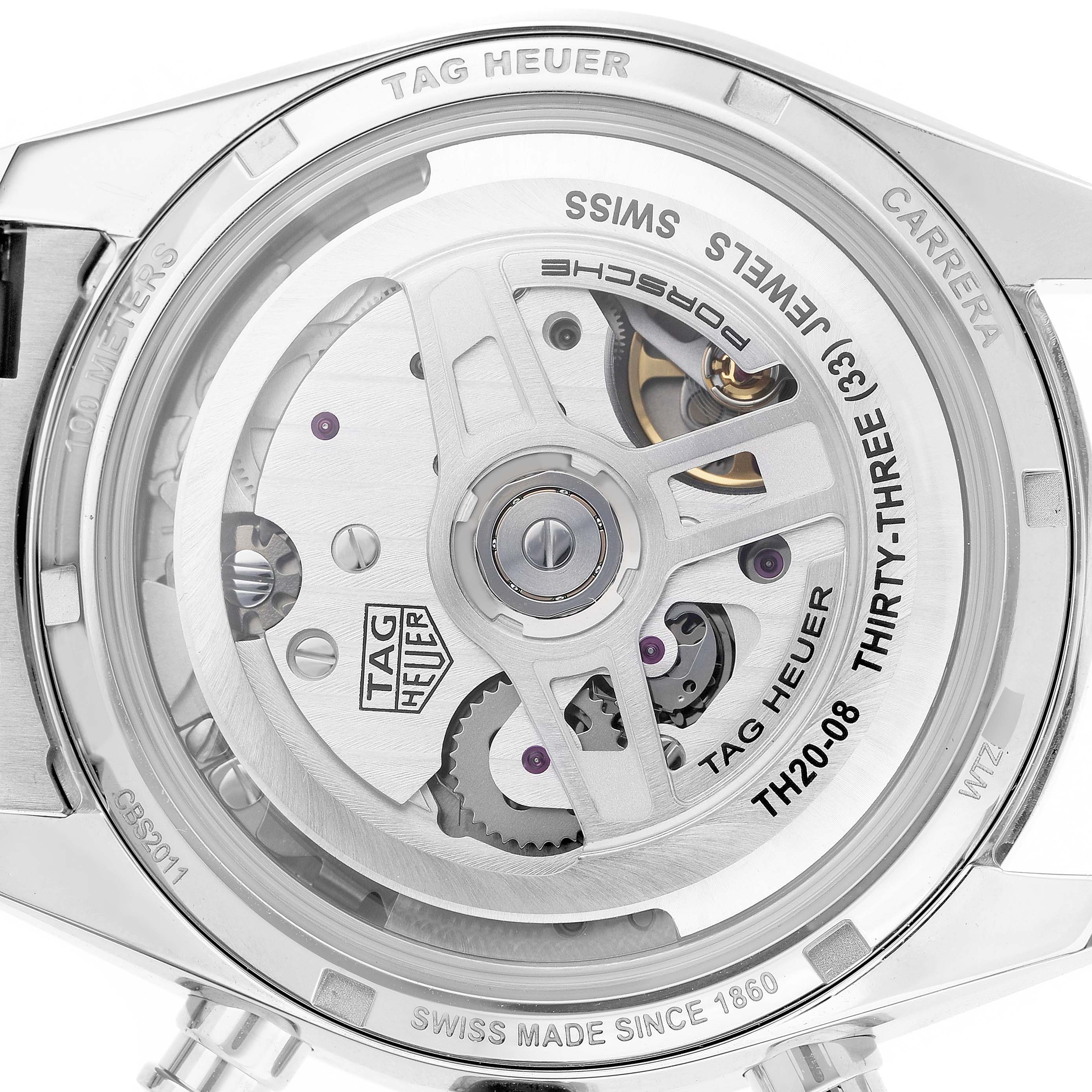 The image shows the back of the Tag Heuer Carrera CBS2011.FC6529 Men's Stainless Steel Silver Dial watch, highlighting its exposed movement and inscriptions.