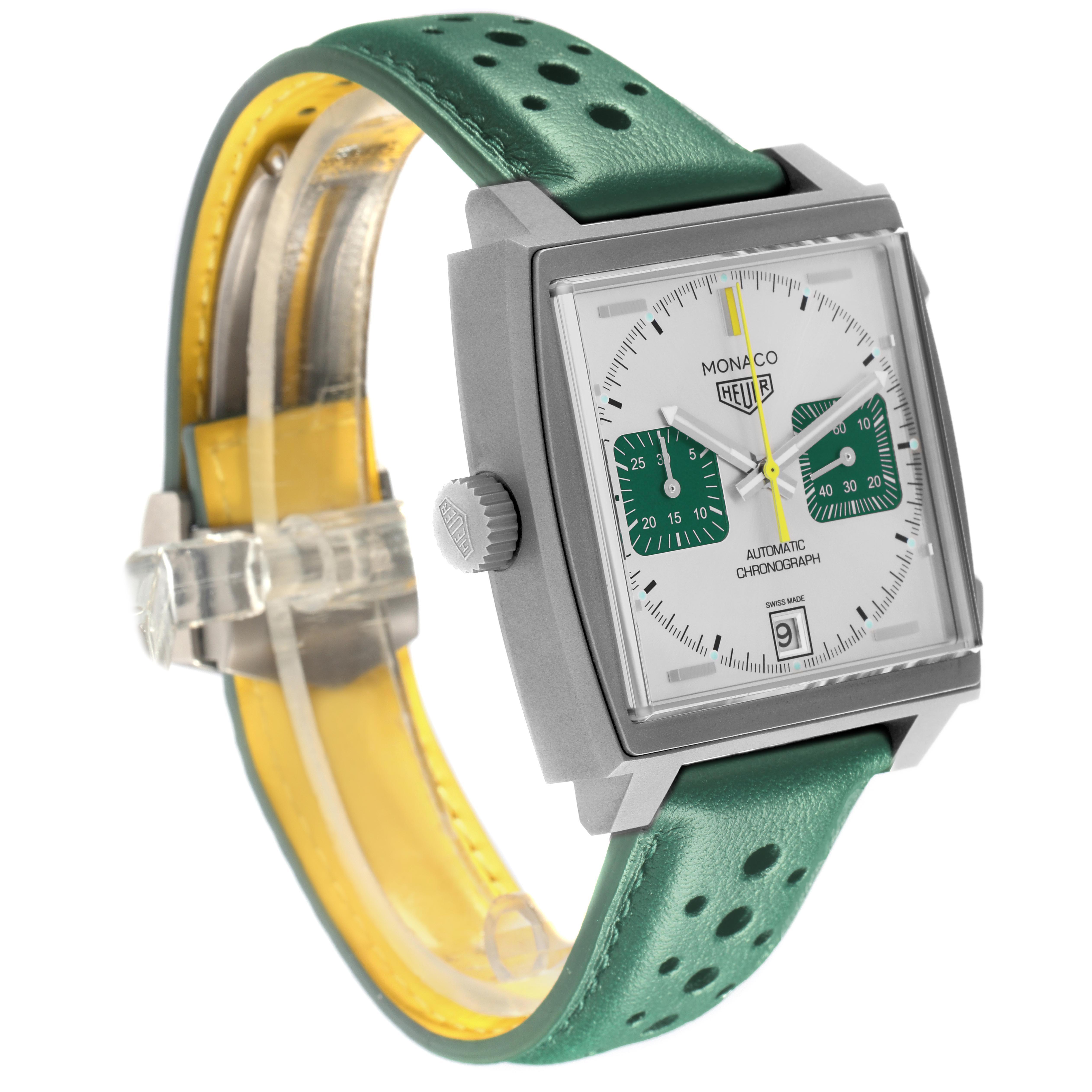 The Tag Heuer Monaco CAW218E.FC6565 Men's Titanium Silver Dial watch is shown at a three-quarter angle, highlighting its square face, dial, crown, and green strap.