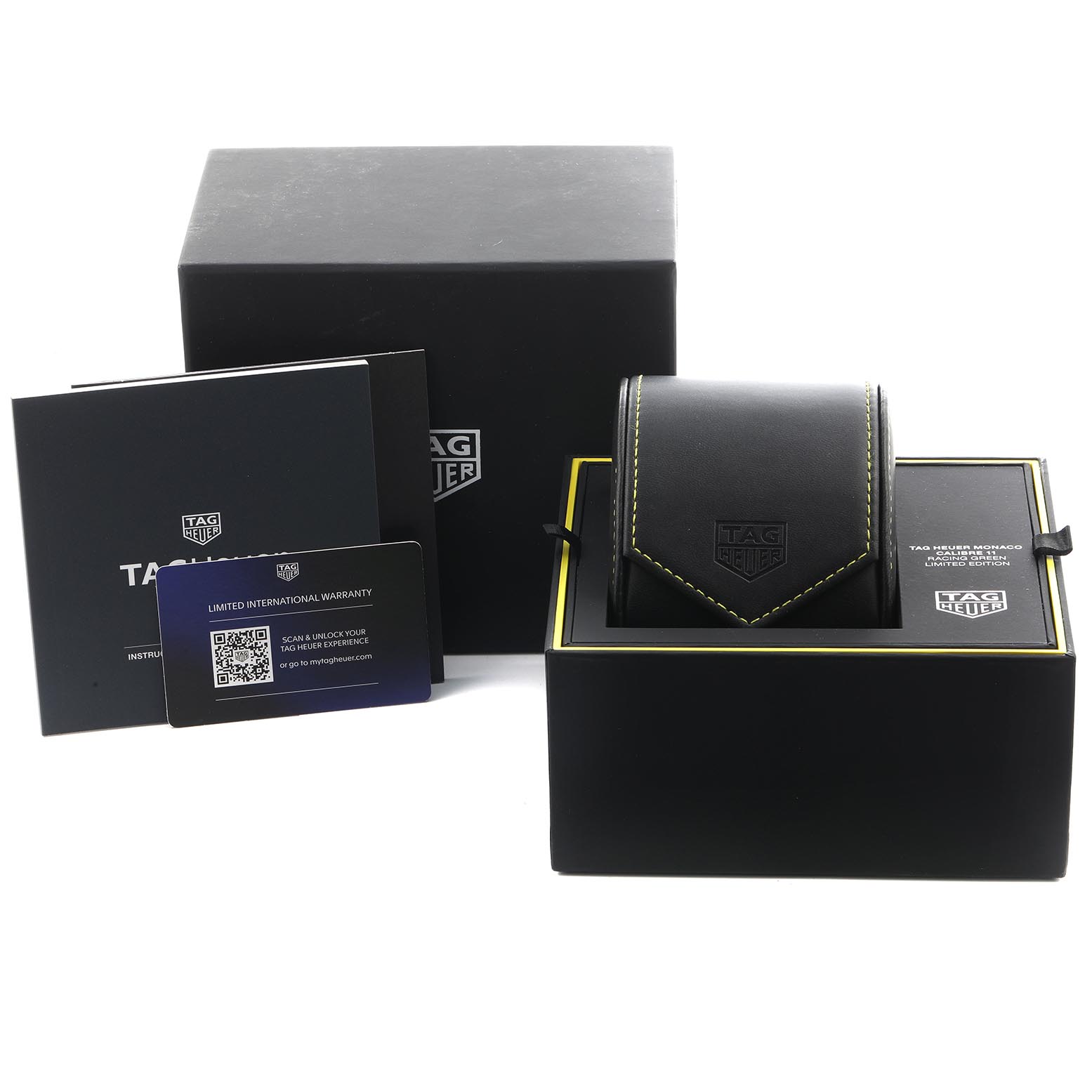 The image shows the packaging and accessories of a Tag Heuer Monaco CAW218E.FC6565 Men's Titanium Silver Dial CAW218E.FC6565 Men's Titanium Silver Dial watch, including a box, warranty card, and instruction booklet.