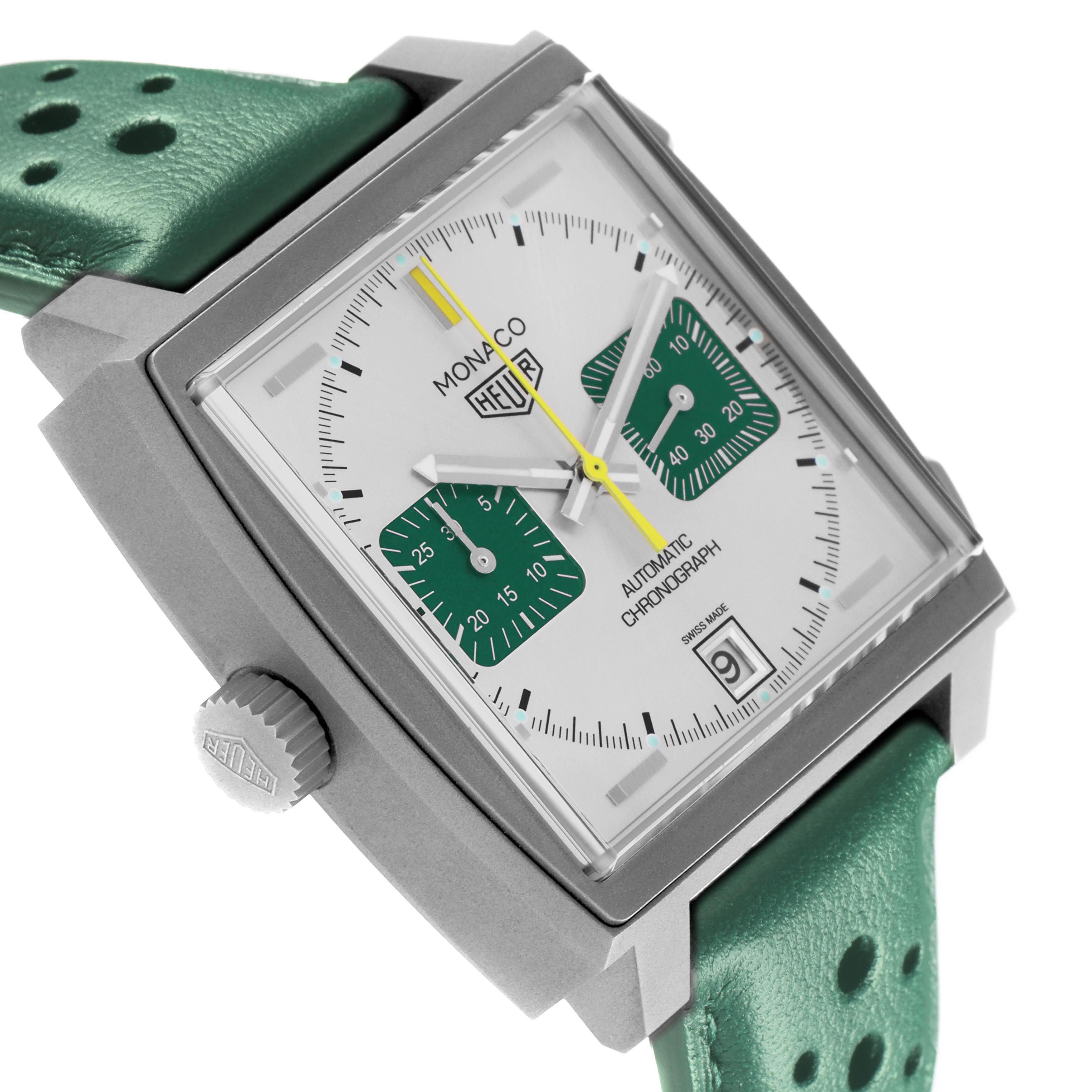 The Tag Heuer Monaco CAW218E.FC6565 Men's Titanium Silver Dial watch is shown at an angled side view, revealing the crown, face, and green perforated strap.