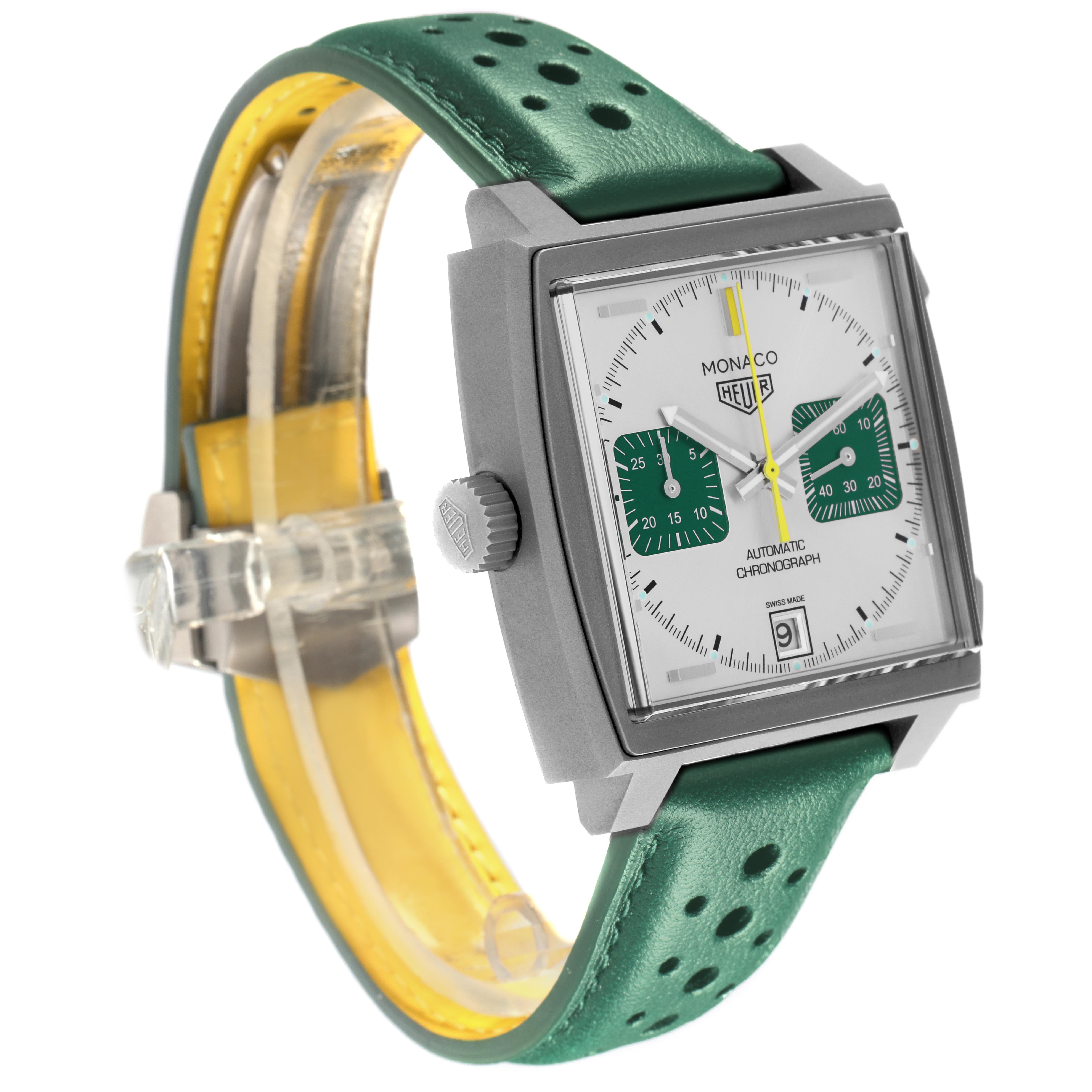 The Tag Heuer Monaco CAW218E.FC6565 Men's Titanium Silver Dial CAW218E.FC6565 Men's Titanium Silver Dial watch is shown at an angle highlighting its square face, side crown, and green perforated strap.