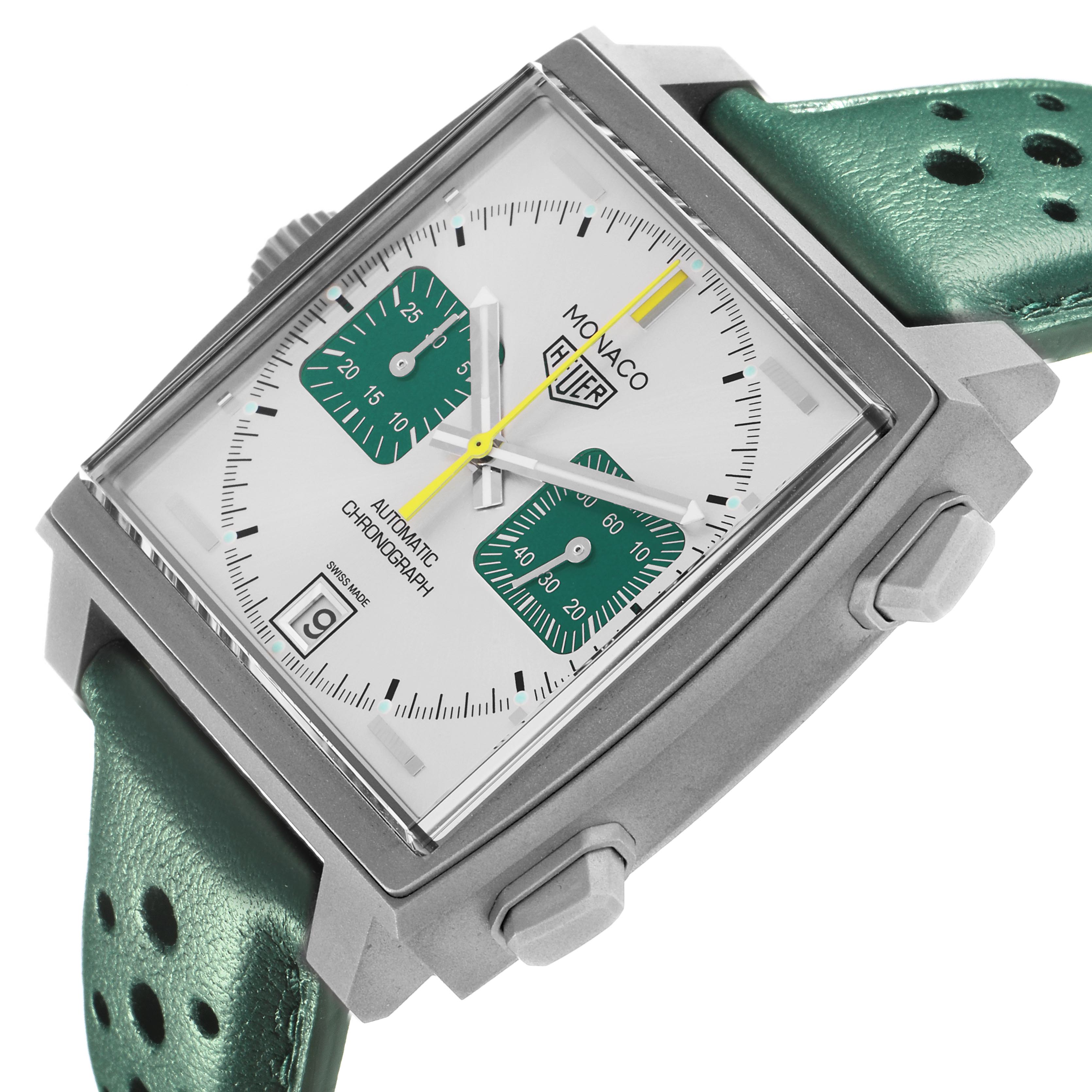 The Tag Heuer Monaco CAW218E.FC6565 Men's Titanium Silver Dial CAW218E.FC6565 Men's Titanium Silver Dial watch is shown at an angled view, highlighting the square face, green subdials, and green strap.