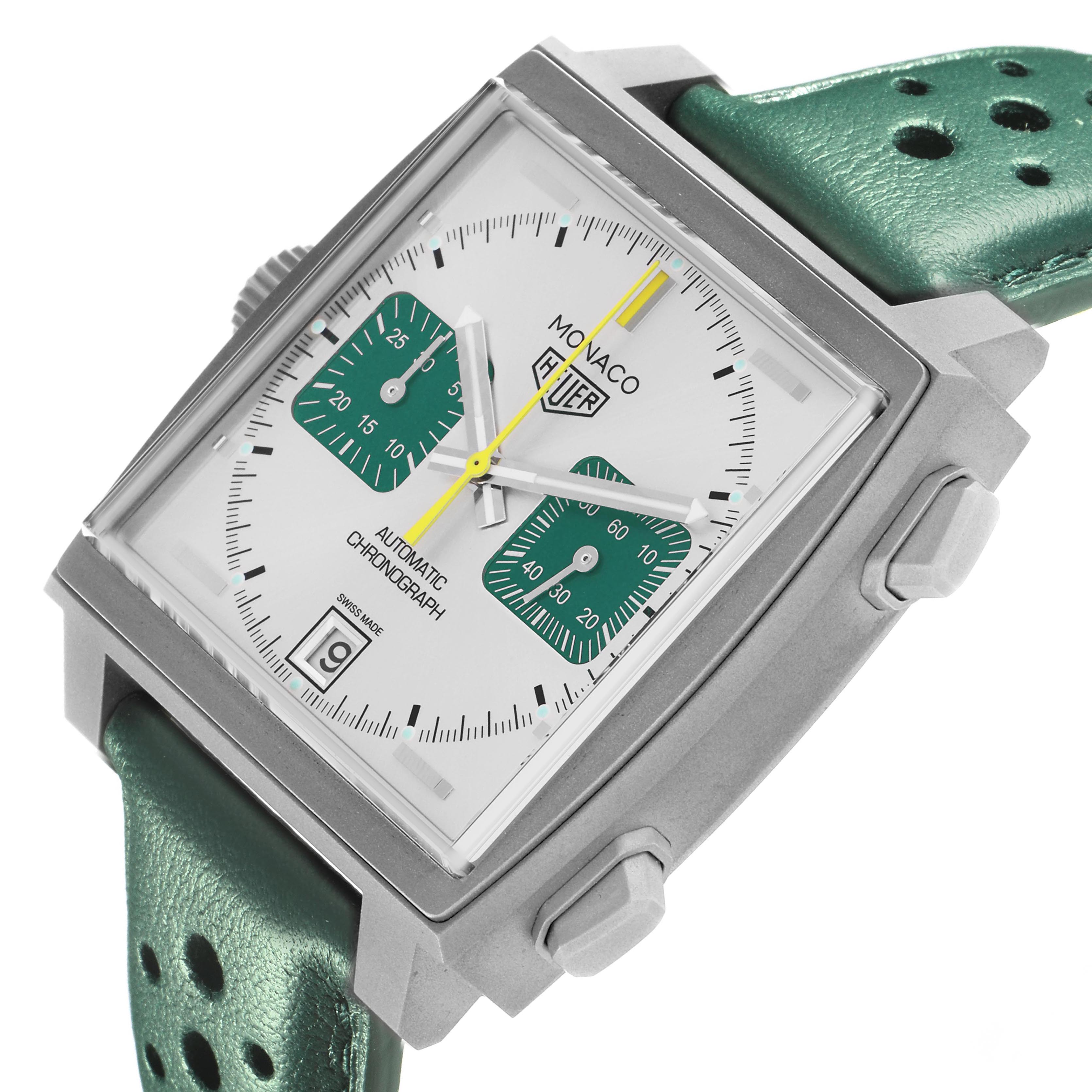 The Tag Heuer Monaco CAW218E.FC6565 Men's Titanium Silver Dial watch is shown at a slight side angle, highlighting the face, buttons, and green strap.