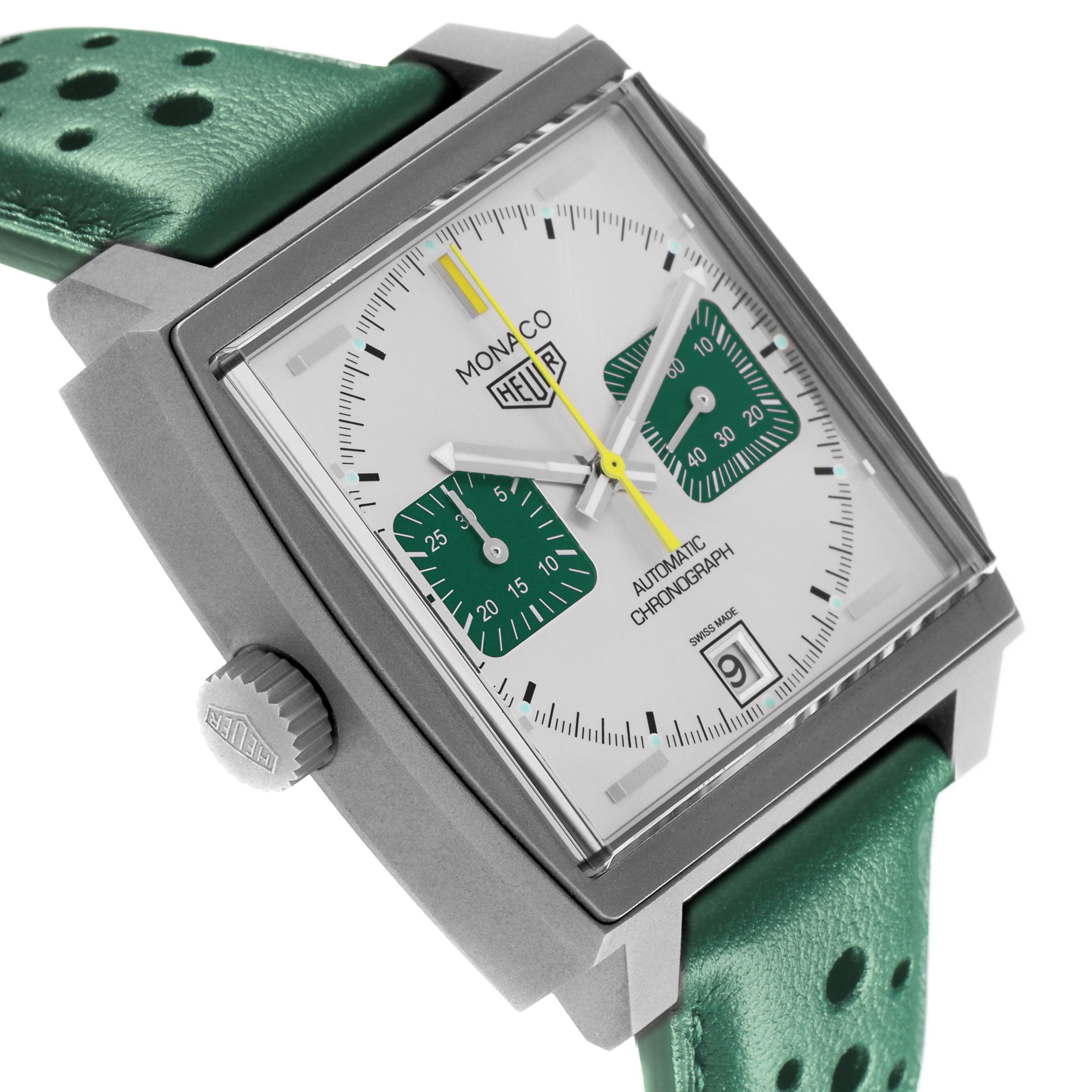 The Tag Heuer Monaco CAW218E.FC6565 Men's Titanium Silver Dial CAW218E.FC6565 Men's Titanium Silver Dial watch is shown from a front angle, highlighting its square face, green strap, and side crown.