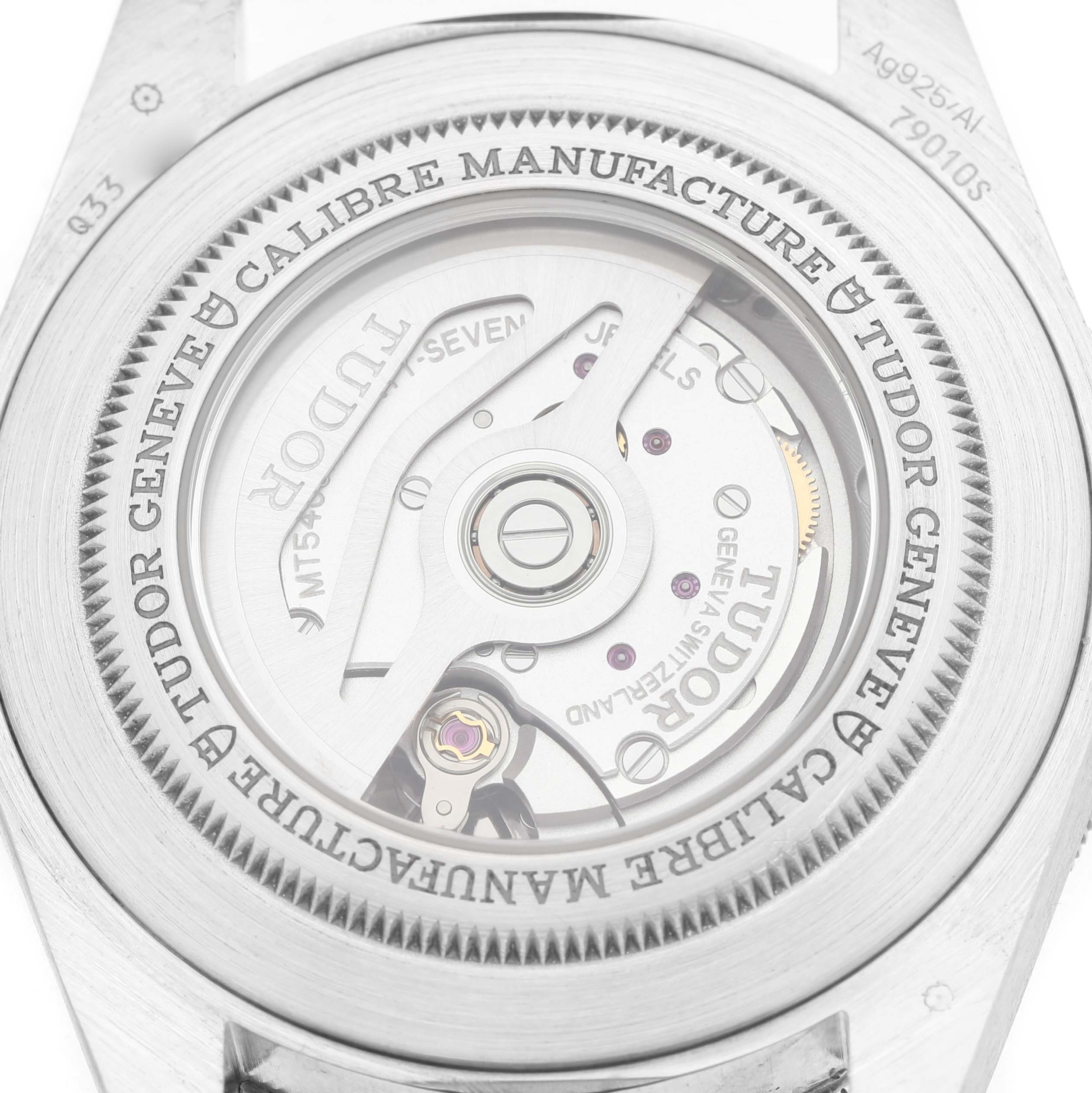 The image shows the back of a Tudor Heritage Black Bay 79010 Men's Stainless Steel Grey Dial watch, highlighting the movement and engraved details.