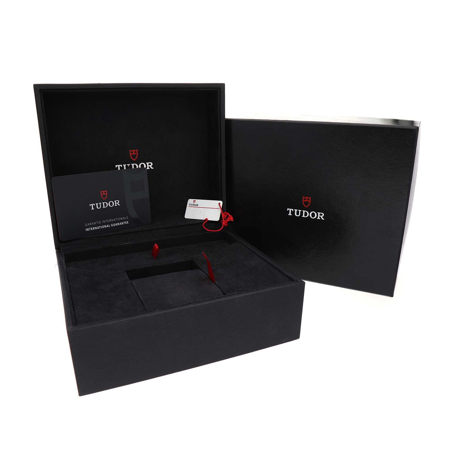The image shows open packaging of the Tudor Heritage Black Bay 79010 Men's Stainless Steel Grey Dial, including a box, tag, and guarantee card.