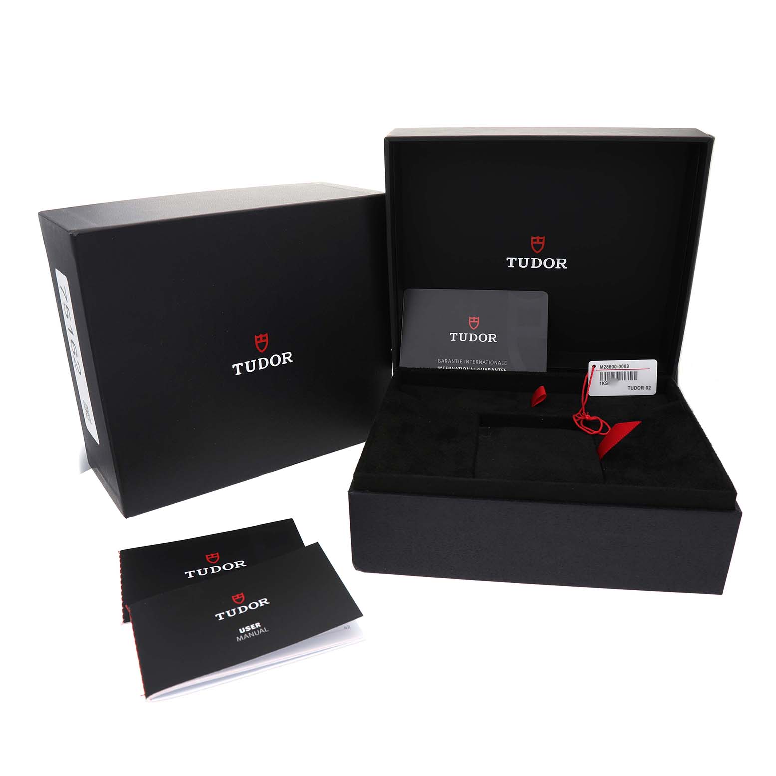 The image shows the Tudor Royal 28600-0003 Men's Stainless Steel Black Dial watch's black box with manuals, warranty card, and a tag inside.